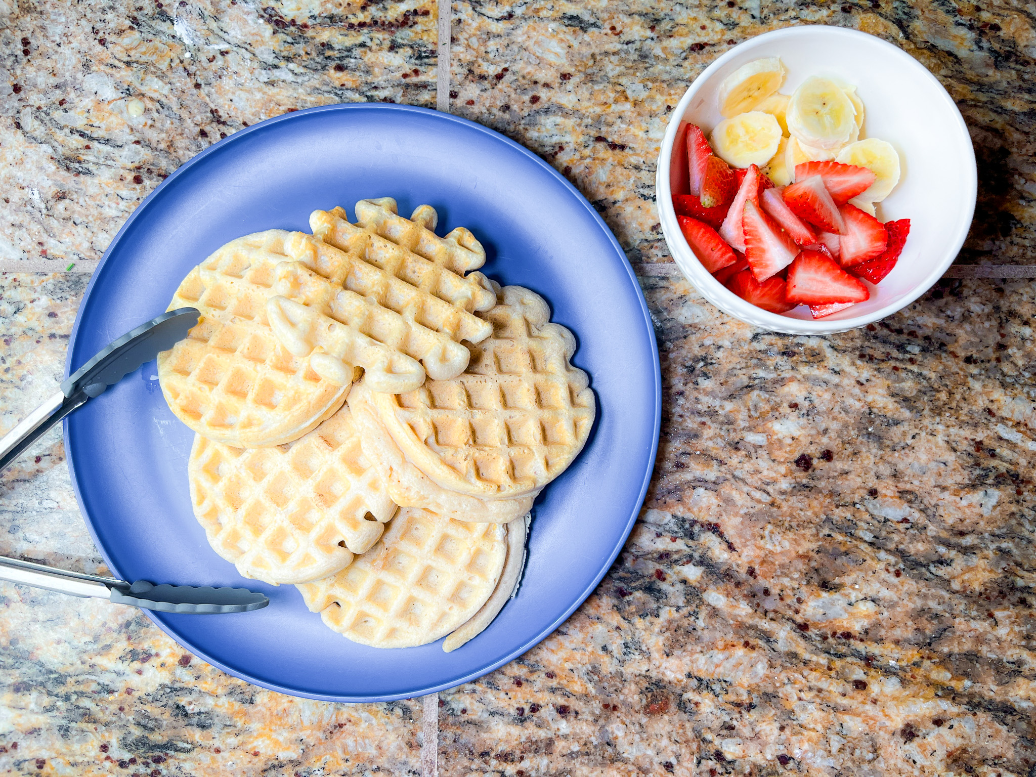 Paleo waffles plated with berries. 