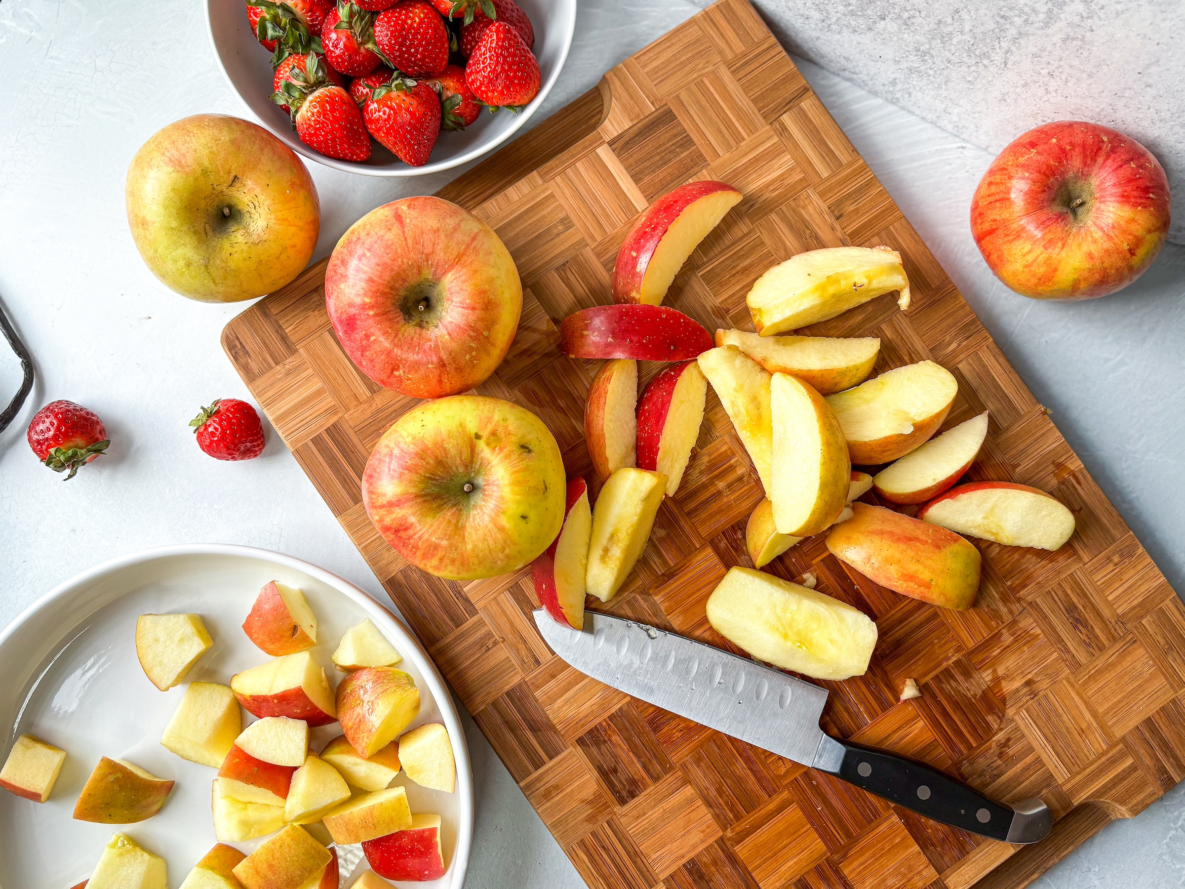 Strawberry applesauce being prepped on a cutting board. 