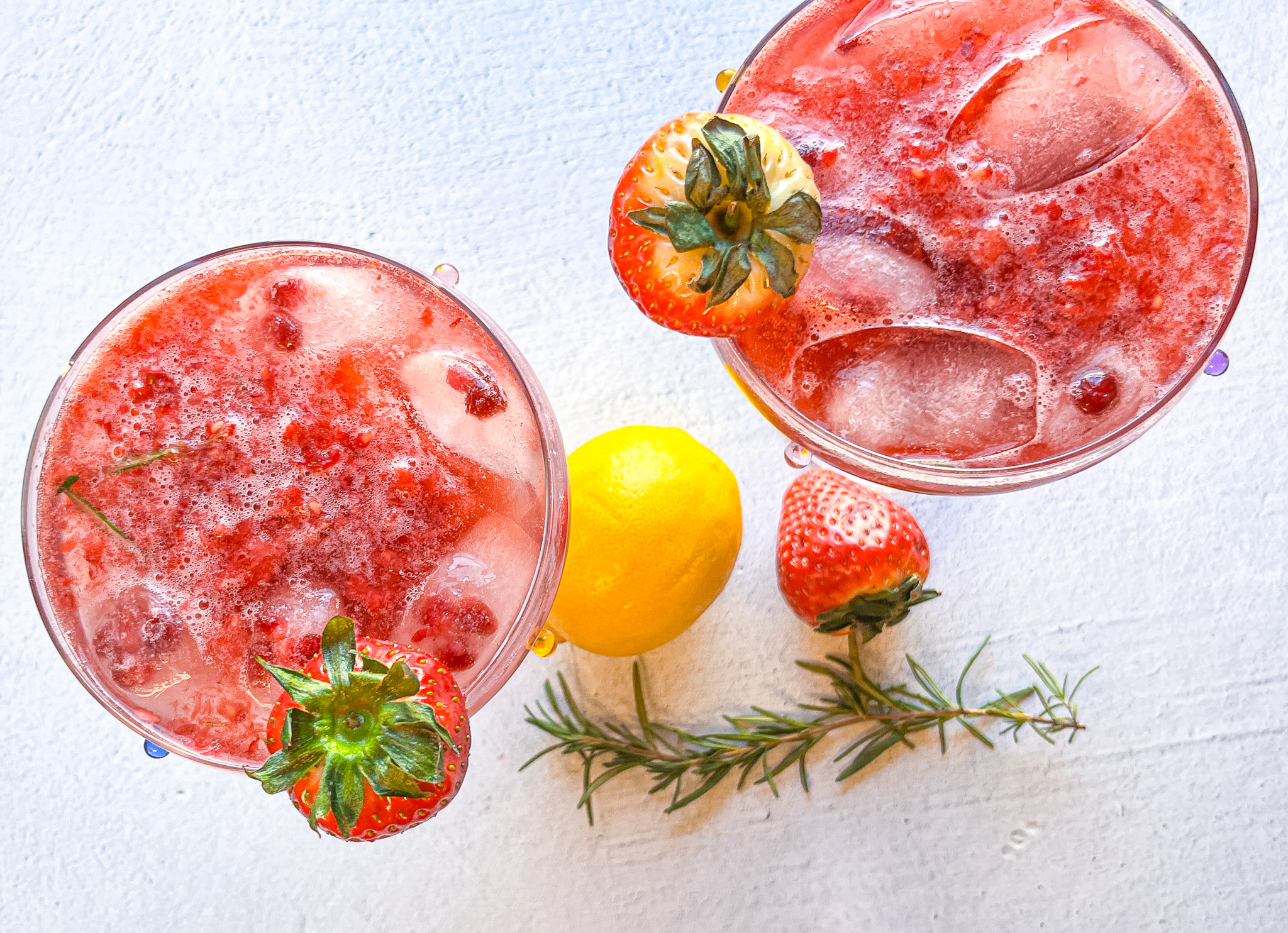 Strawberry sour mocktail in two martini glasses, finished. 