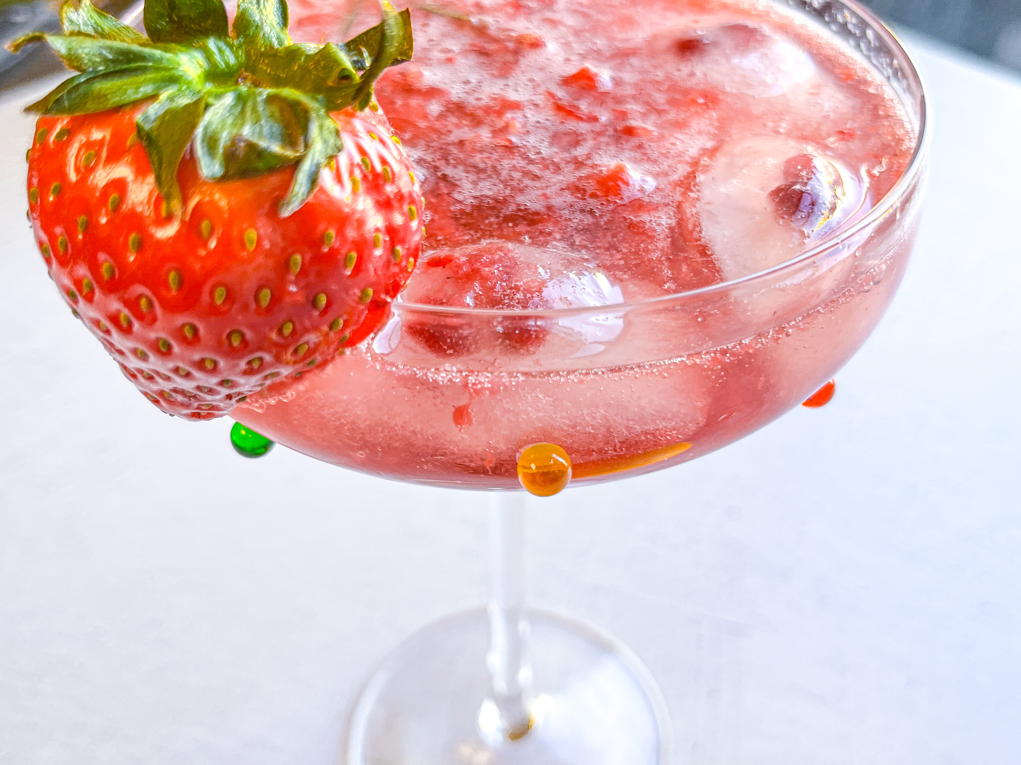 Close up of the strawberry sour mocktail in a martini glass. 