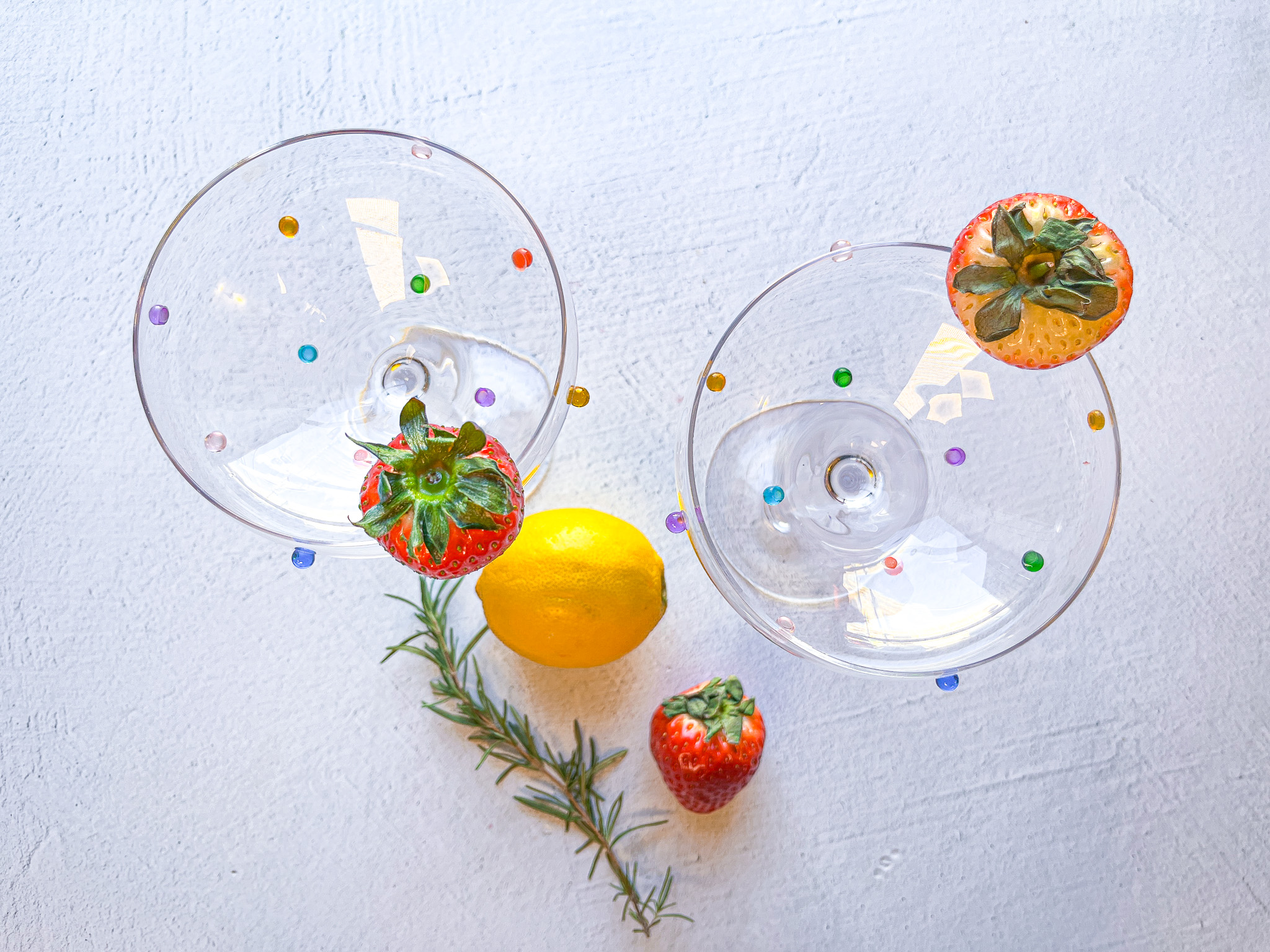 Strawberry sour mocktail prep with empty glasses. 