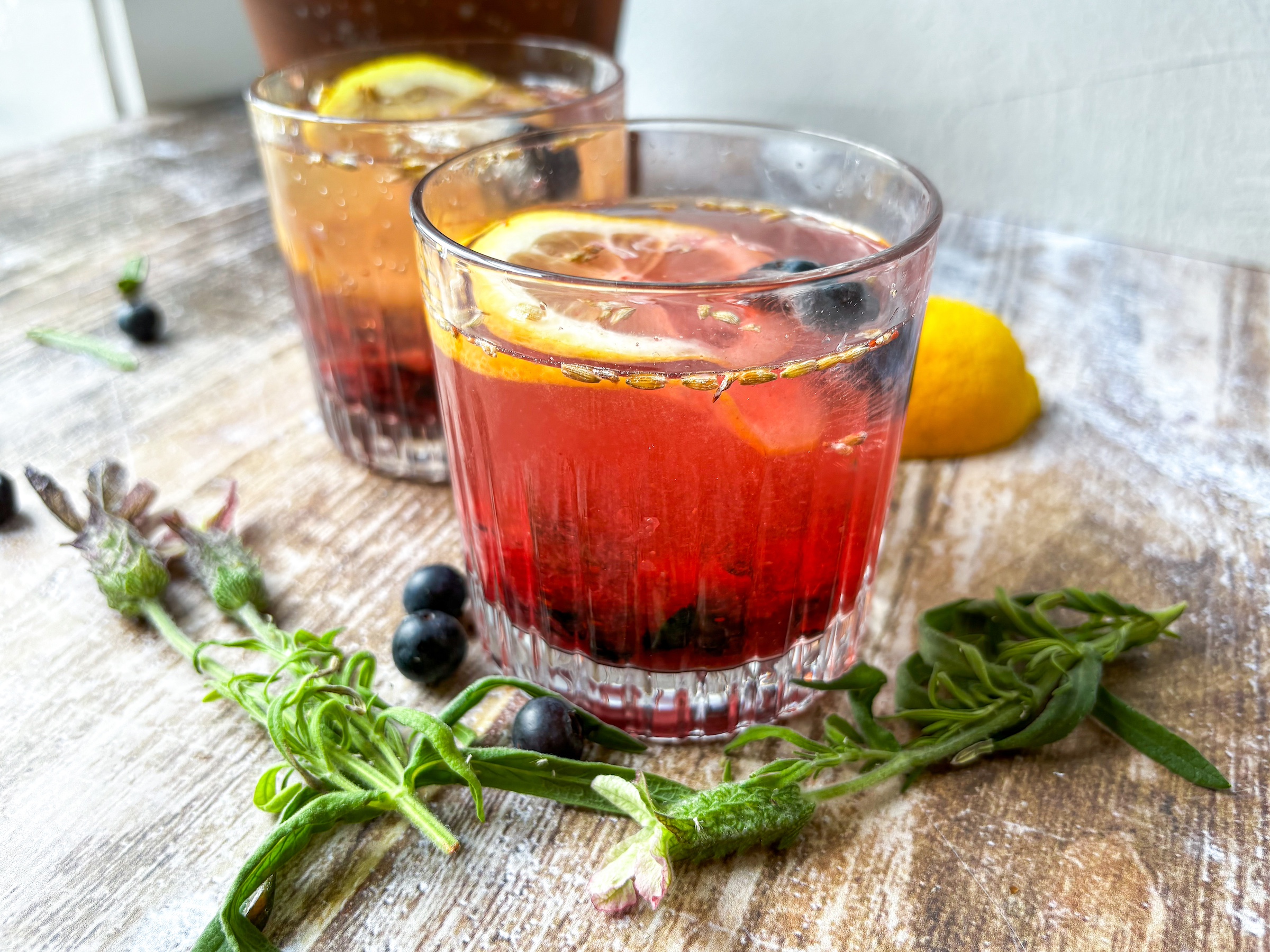 Blueberry-lavender mocktail finished in two glasses. 