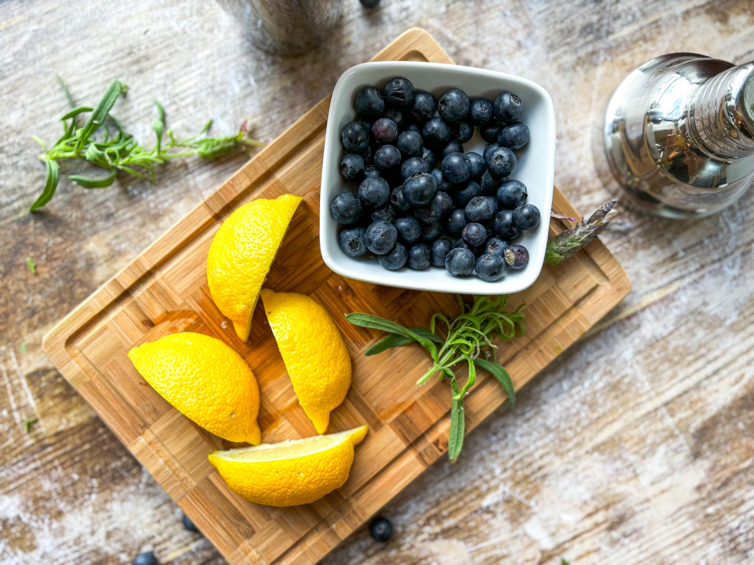 Blueberry-lavender mocktail prep on a cutting board. 