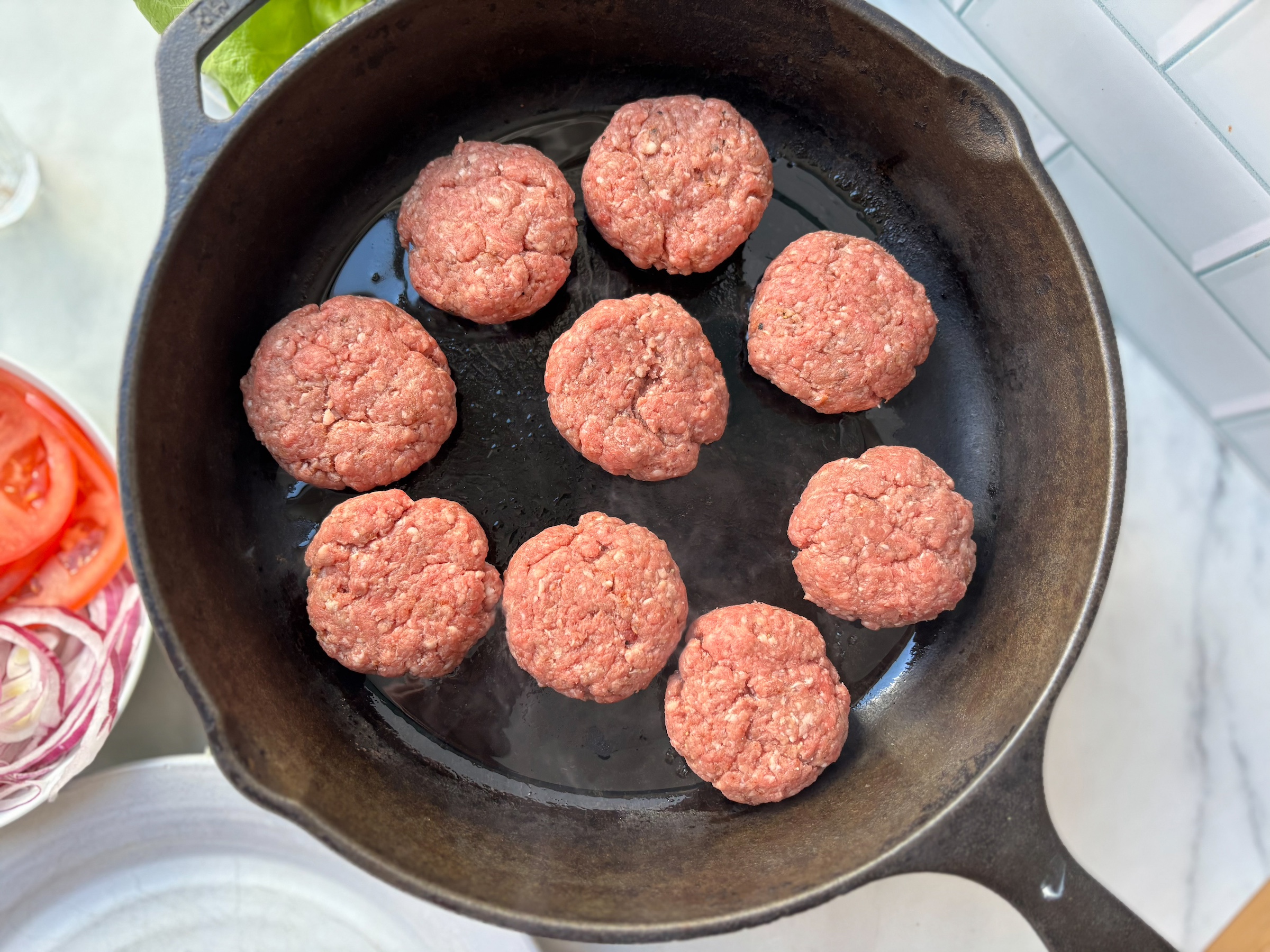 Prepping ground beef for bunless sliders in a cast iron. 