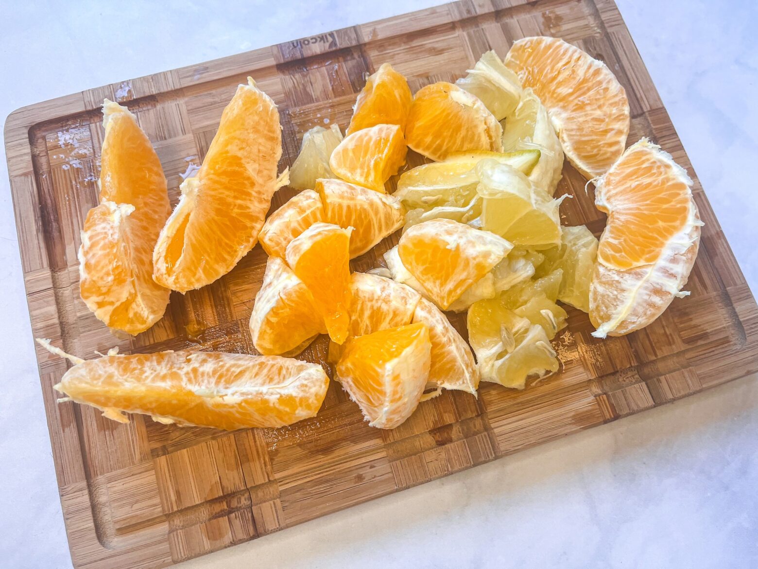 Prepping to make the elderberry citrus elixir by slicing oranges.