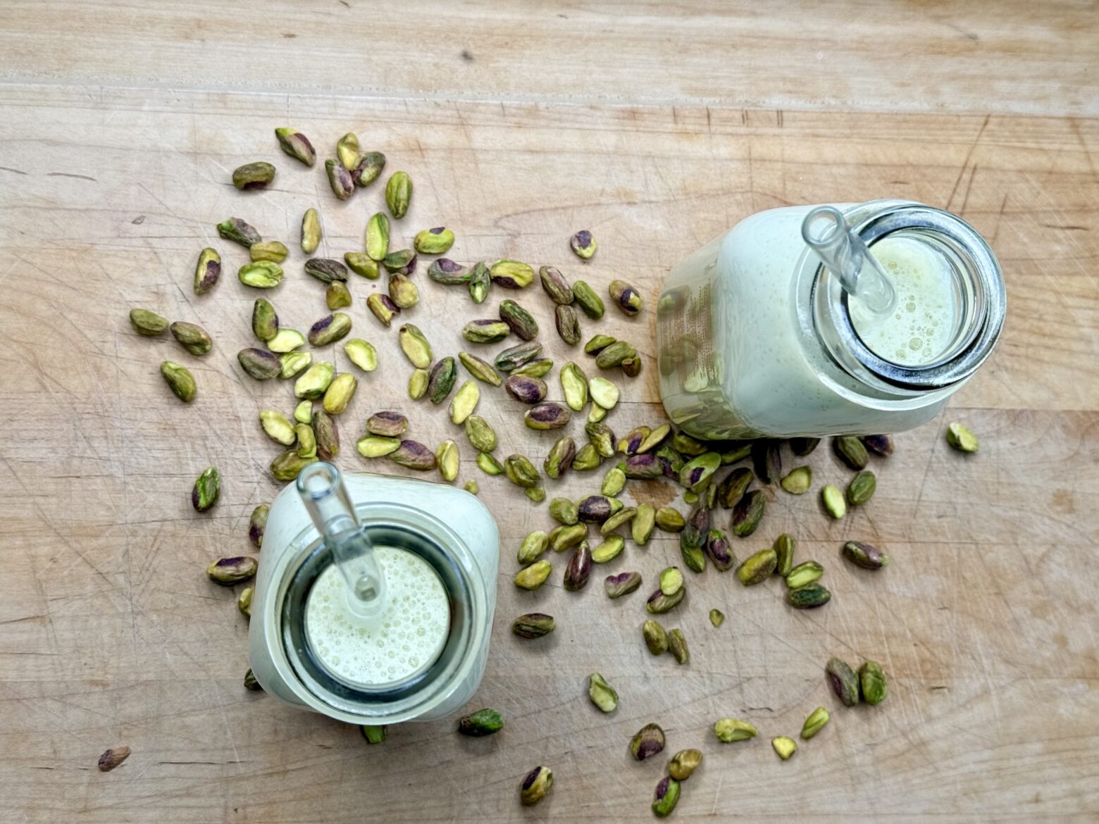 Overhead shot of pistachio milk on a cutting board.