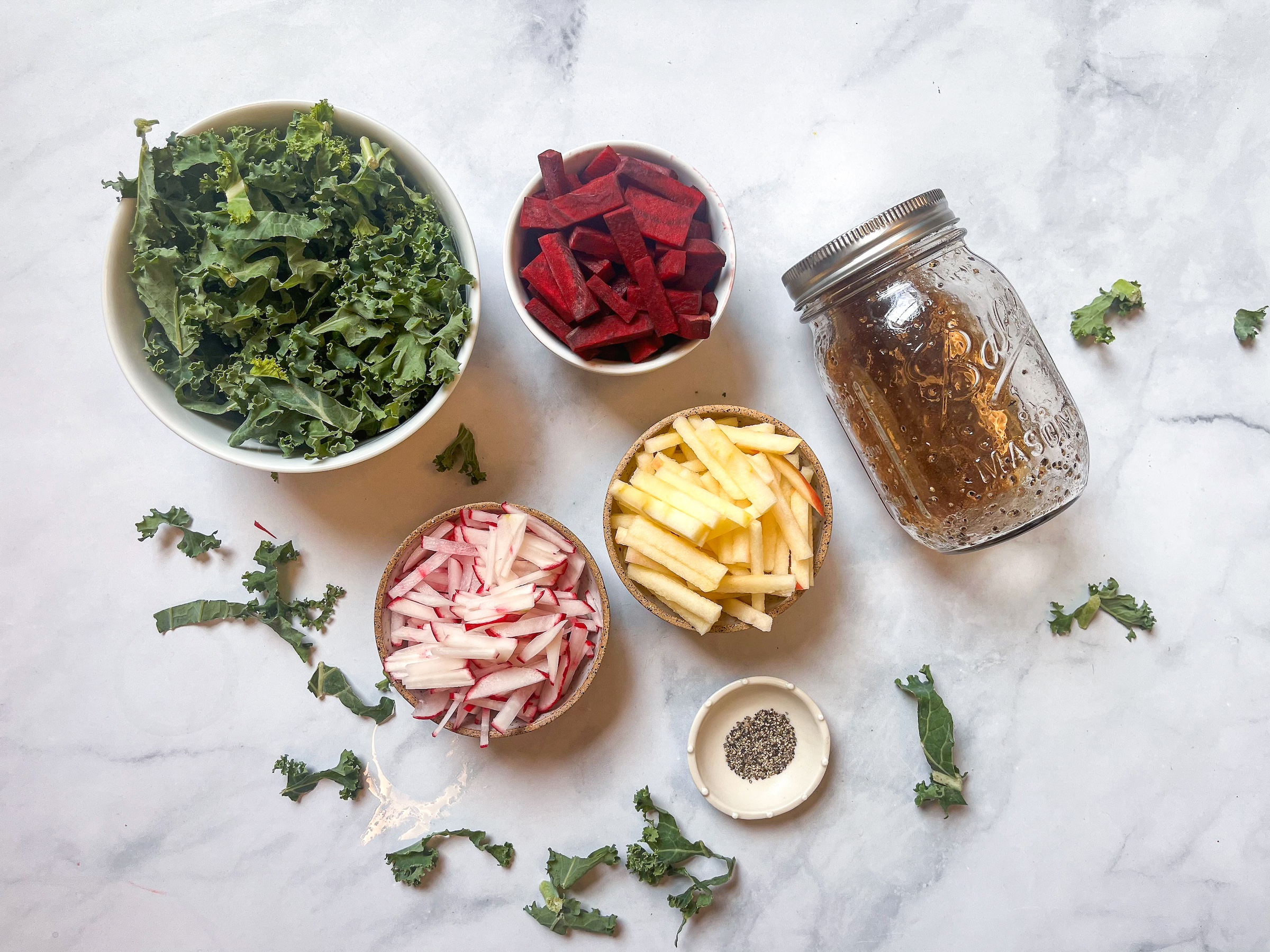 Red root kale salad ingredients are being prepped. 