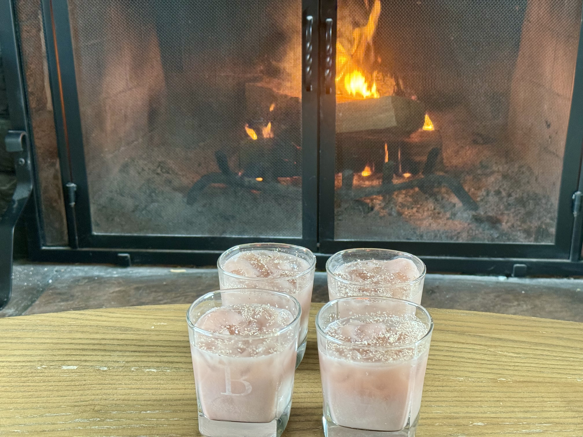 Tart cherry juice mocktails in front of the fire place. 