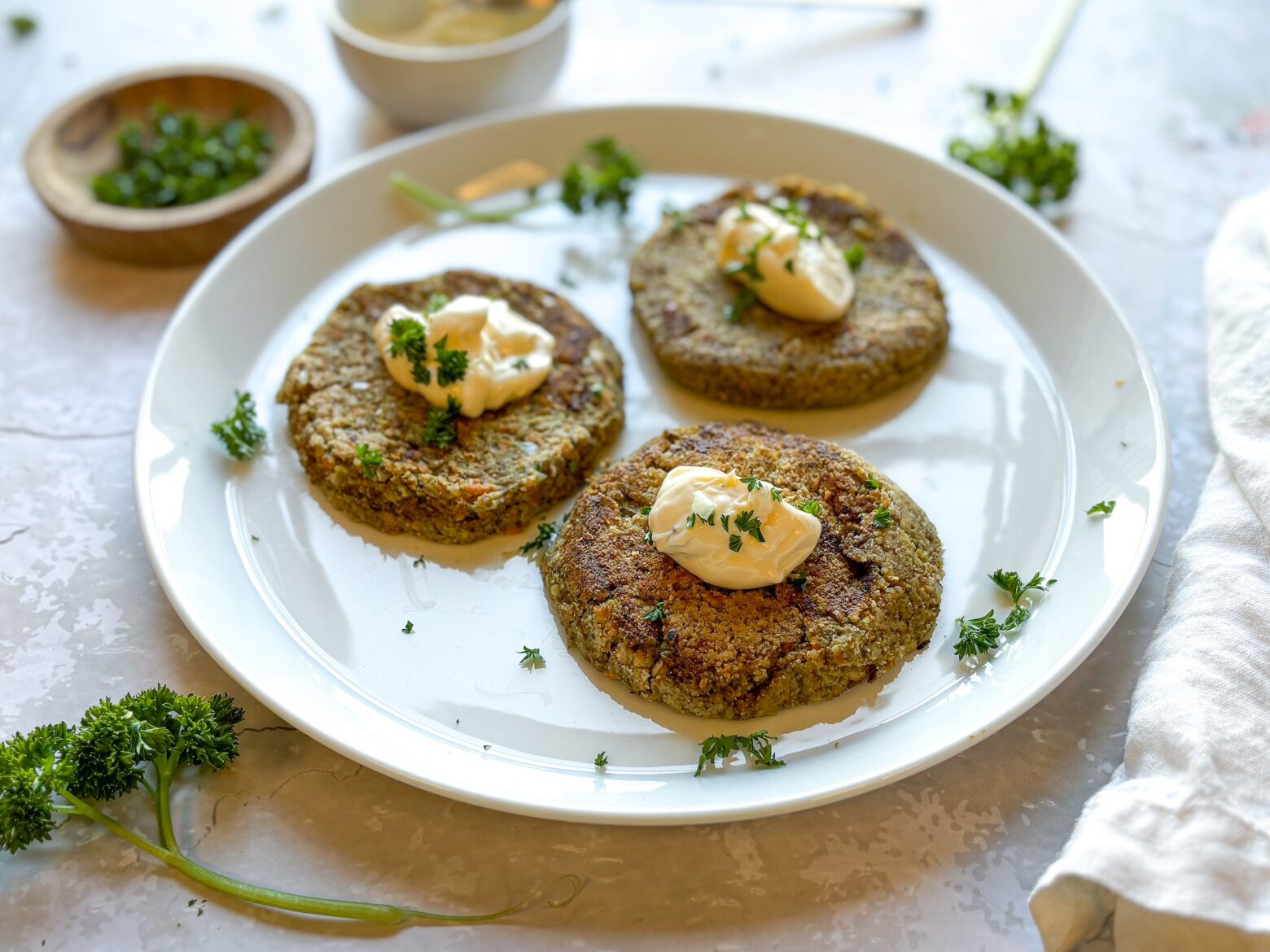 Vegan crab cakes finished and topped with mayo.