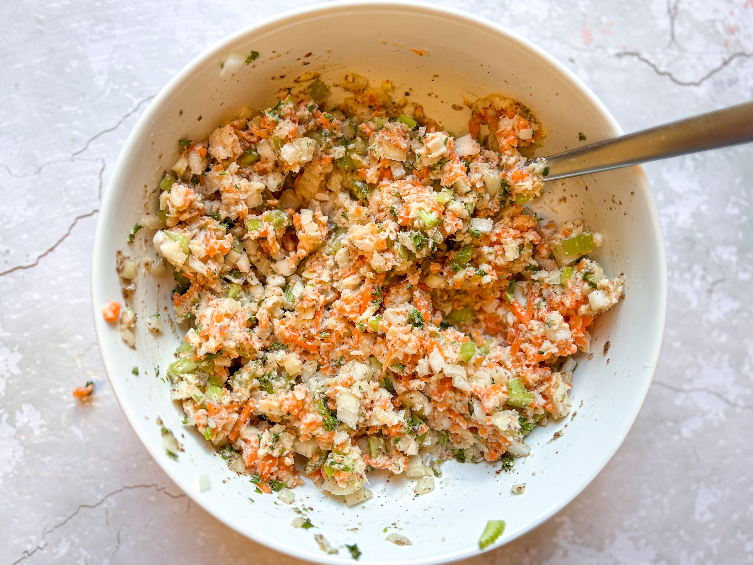 Vegan crab cakes being mixed in a bowl. 