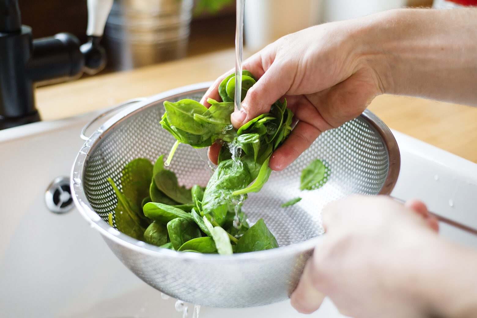 Someone washing spinach.