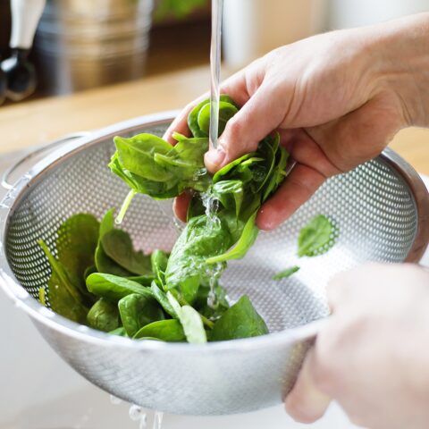 Someone washing spinach.