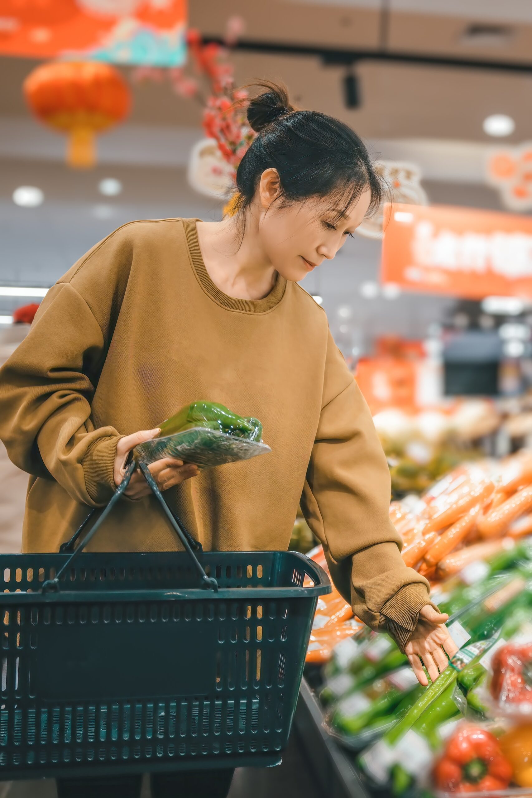 Women looking through produce, choosing groceries.