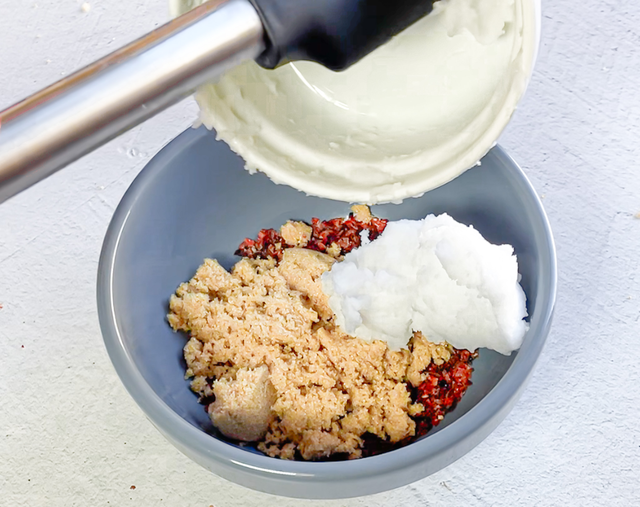 Exfoliating sugar scrub being mixed in a big bowl.