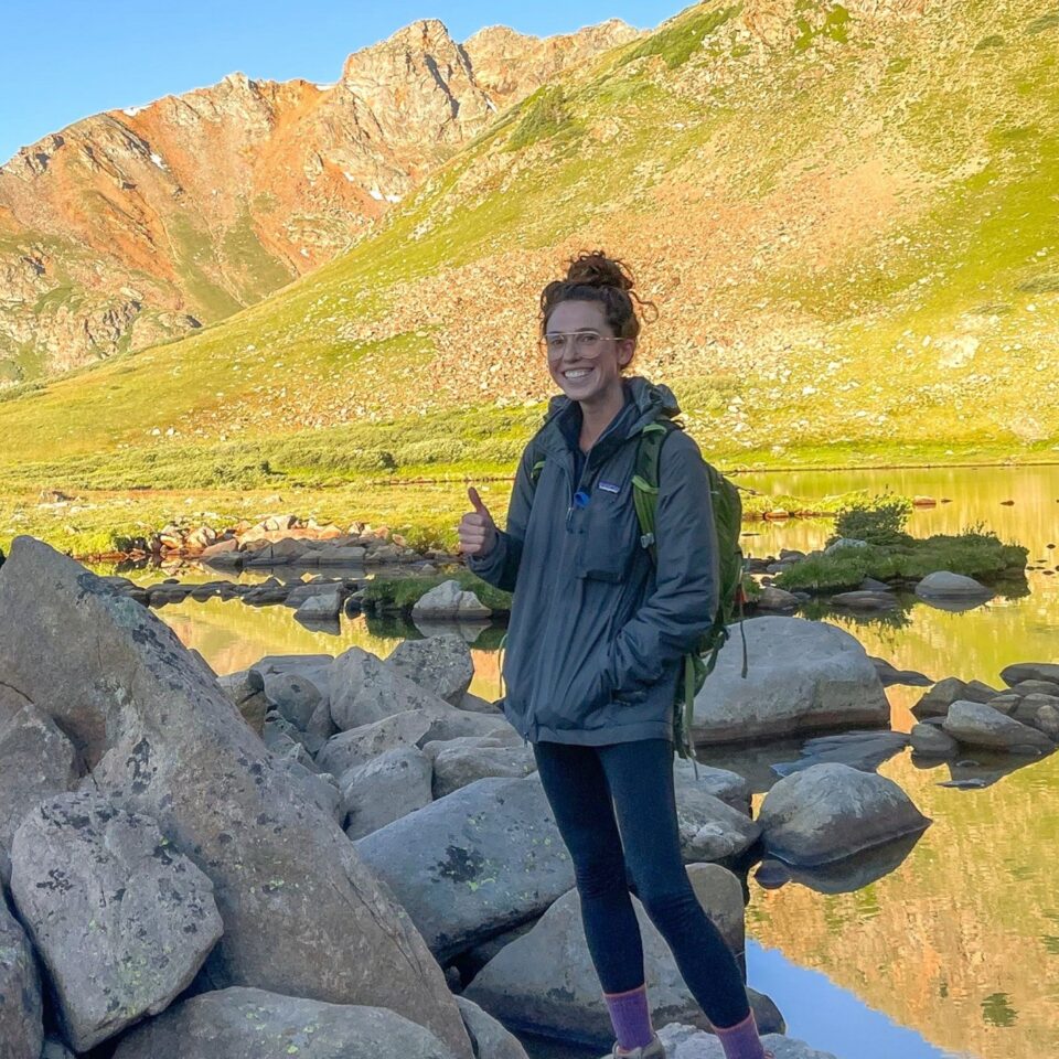 Dr. Griffin McMath standing in front of a mountain lake