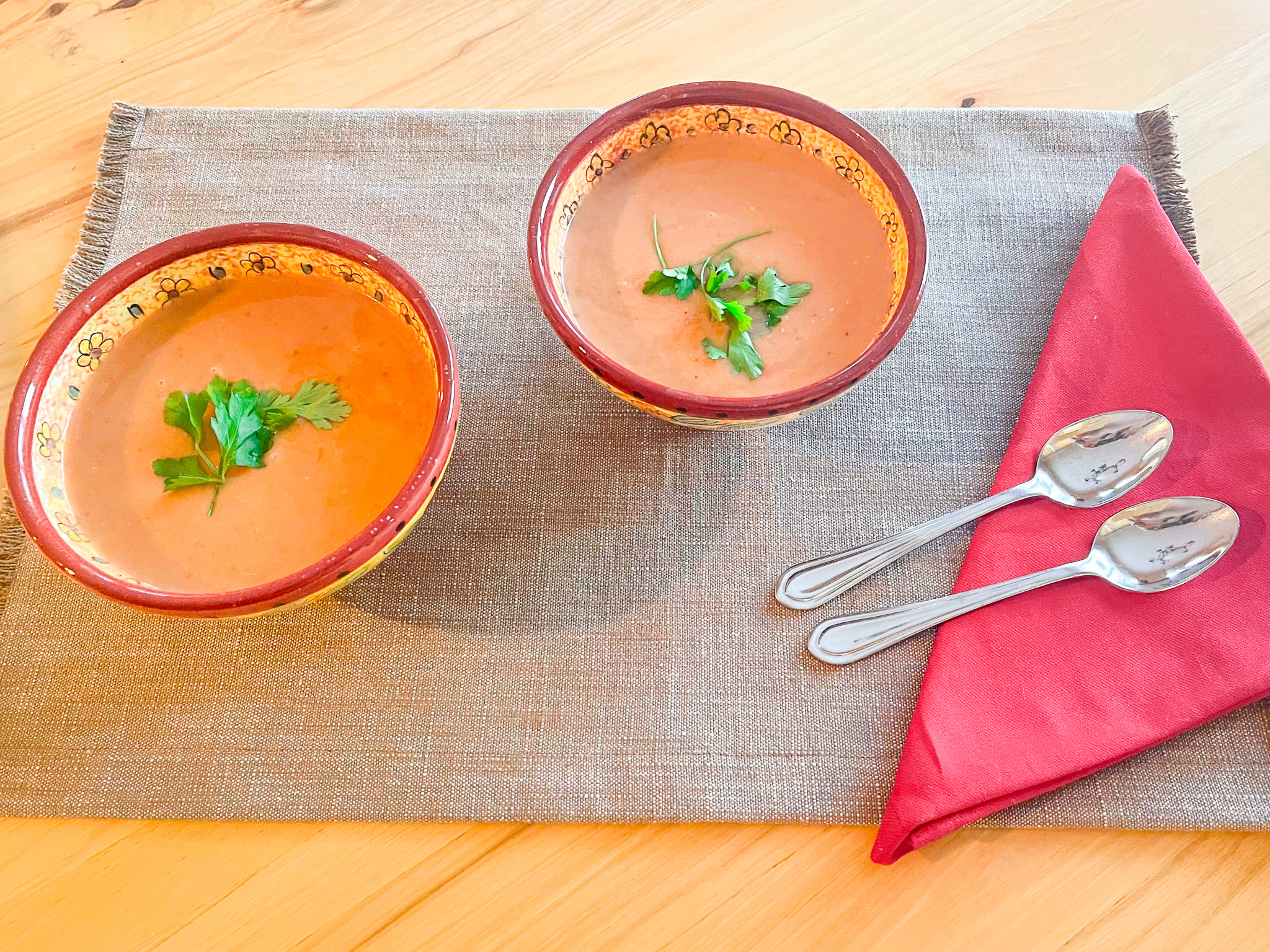 Lobster bisque finished in bowls on a placemat.