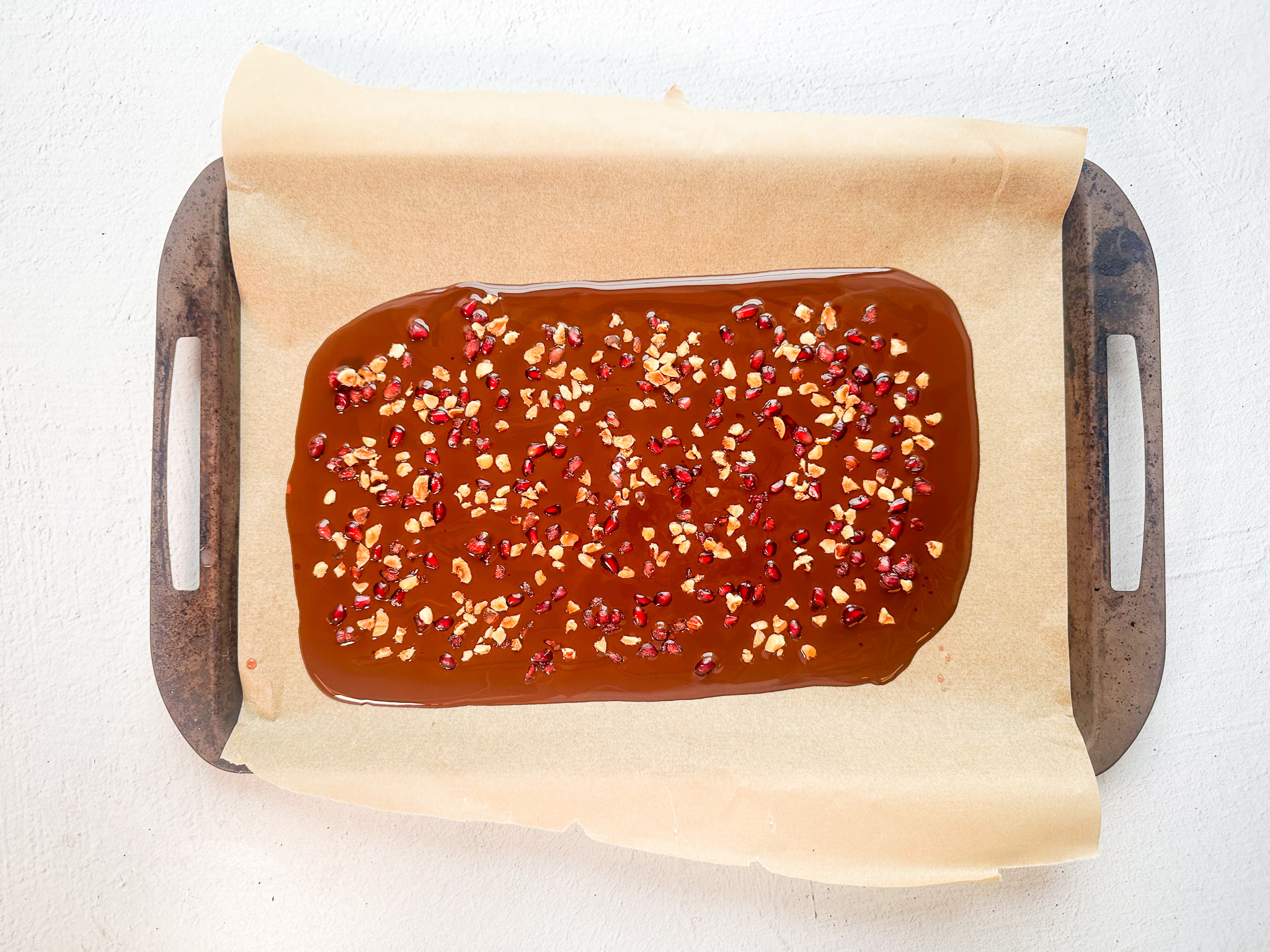 Pomegranate Chocolate bark prep with toppings and melted chocolate. 