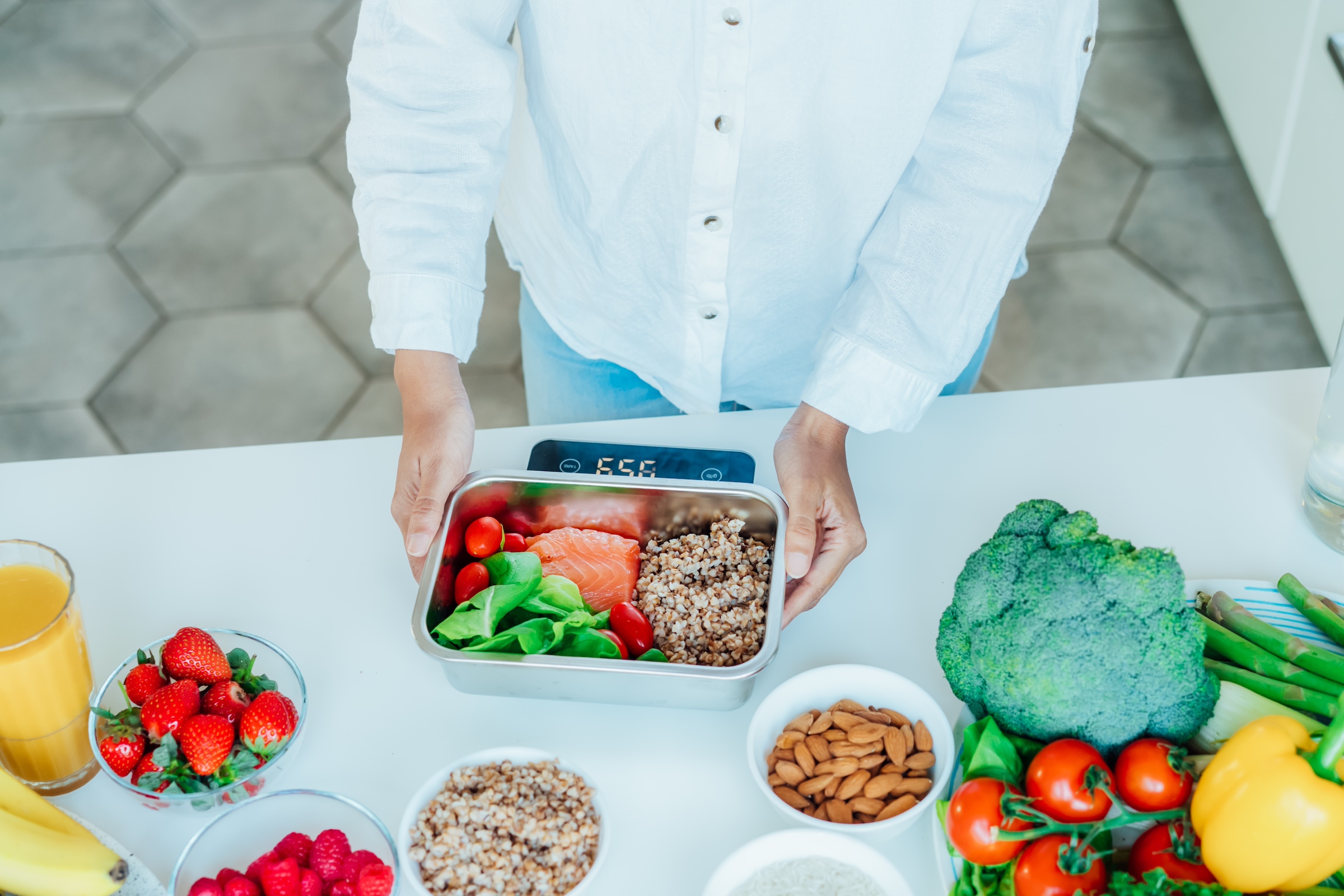 Weighting food on a scale with portions.