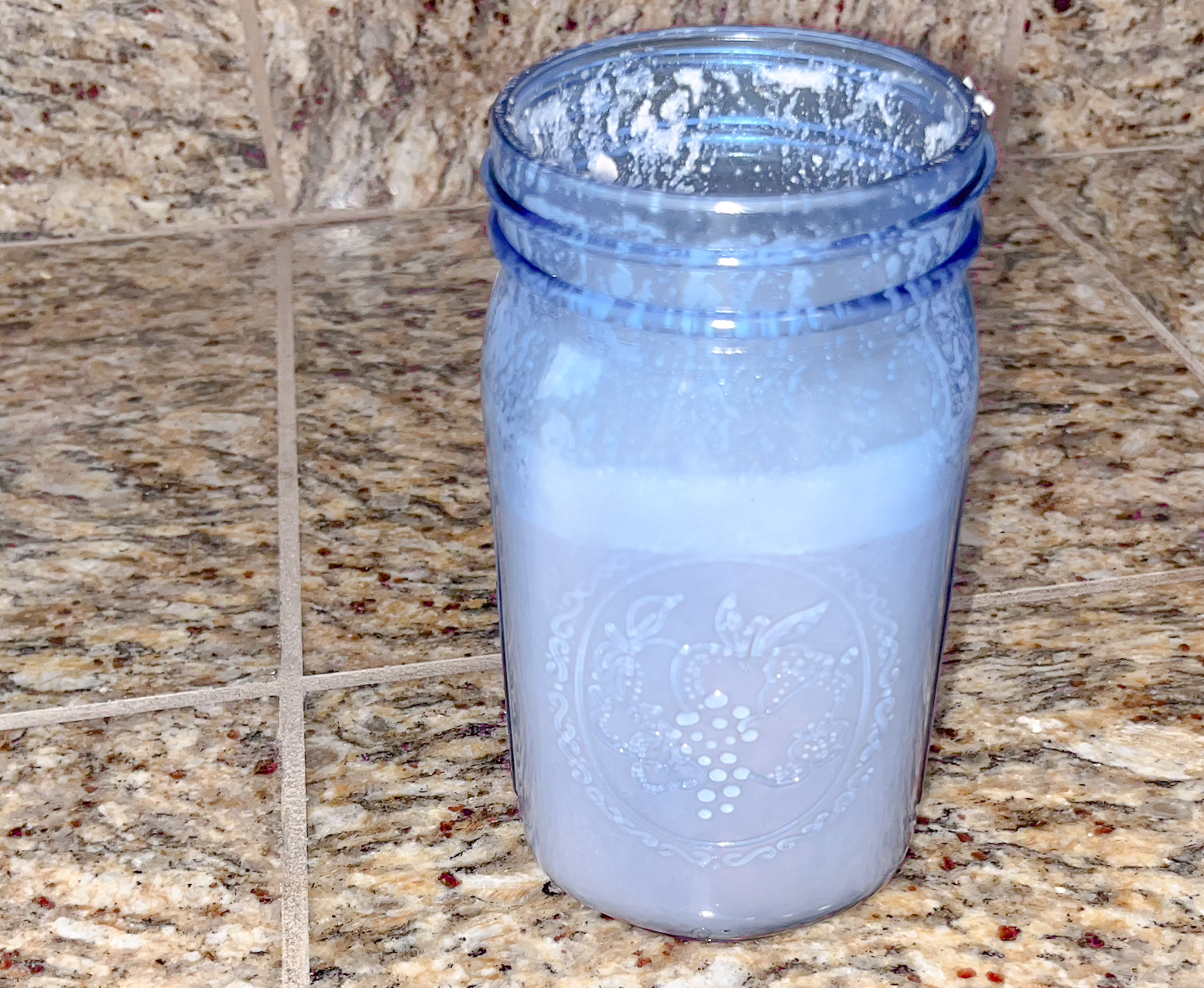 Raspberry almond milk finished in a blue mason jar. 