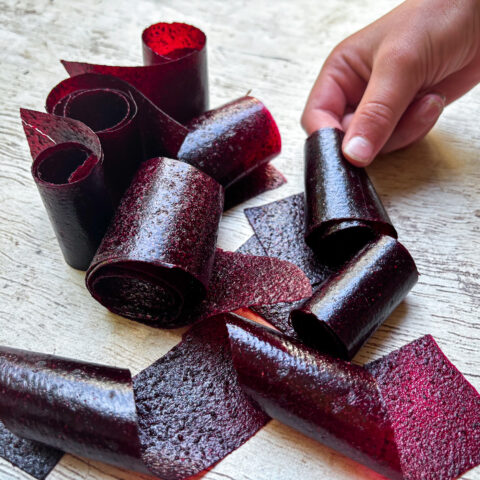 Grabbing fruit roll ups laid out on table