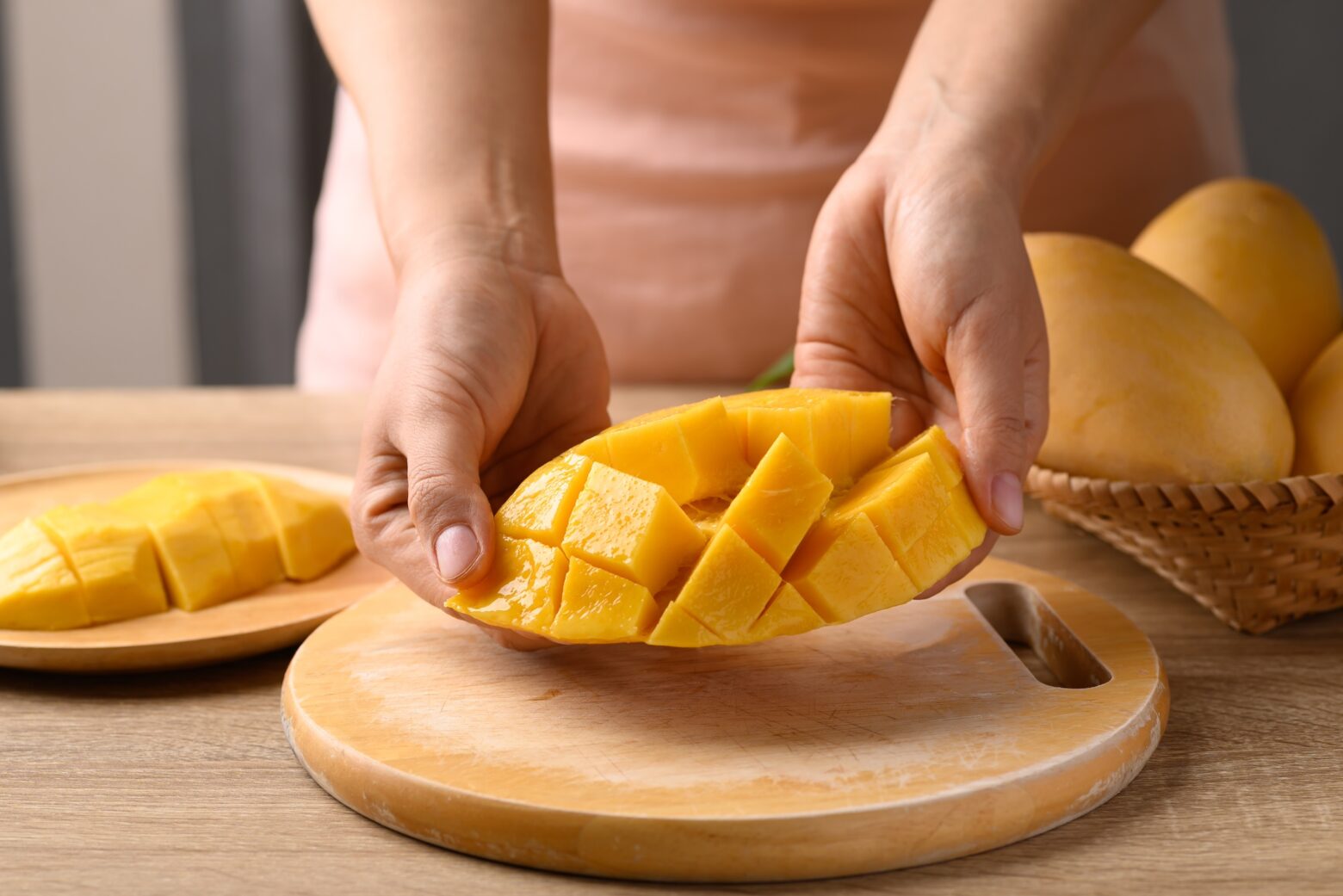 A mango sliced in half and cubed.