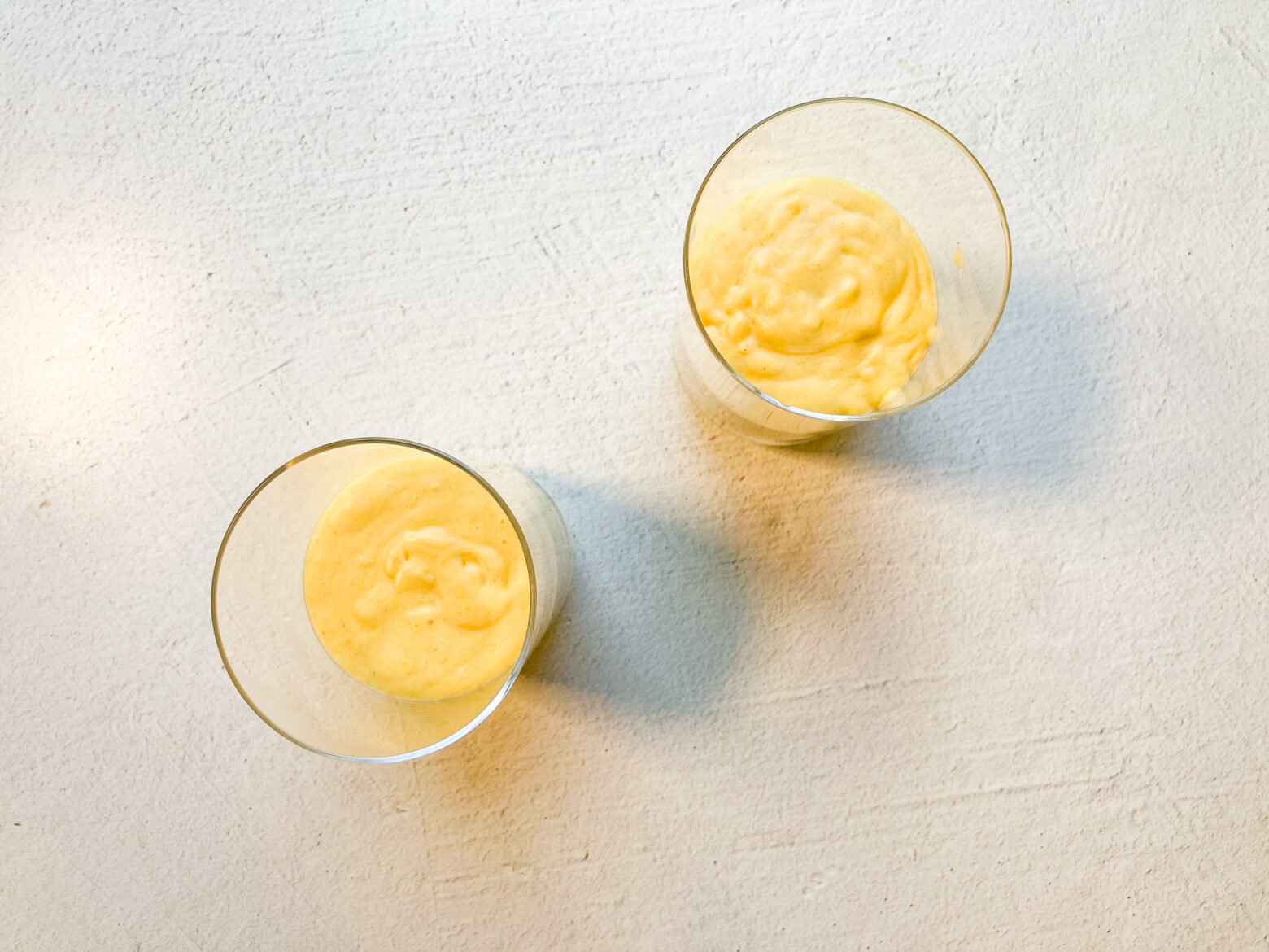 Mango lassi finished from above view with no toppings.