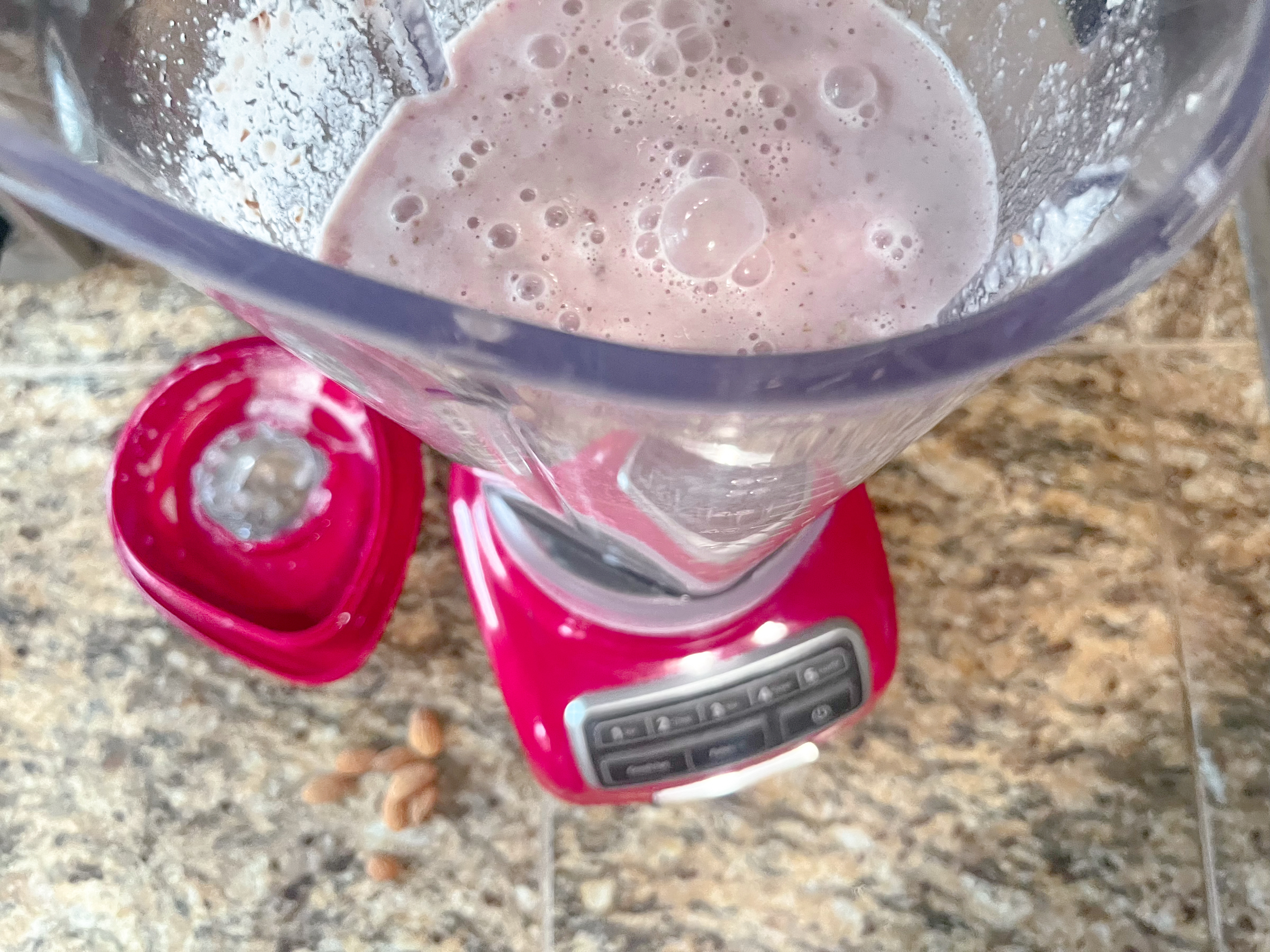 Raspberry almond milk in a blender from above. 