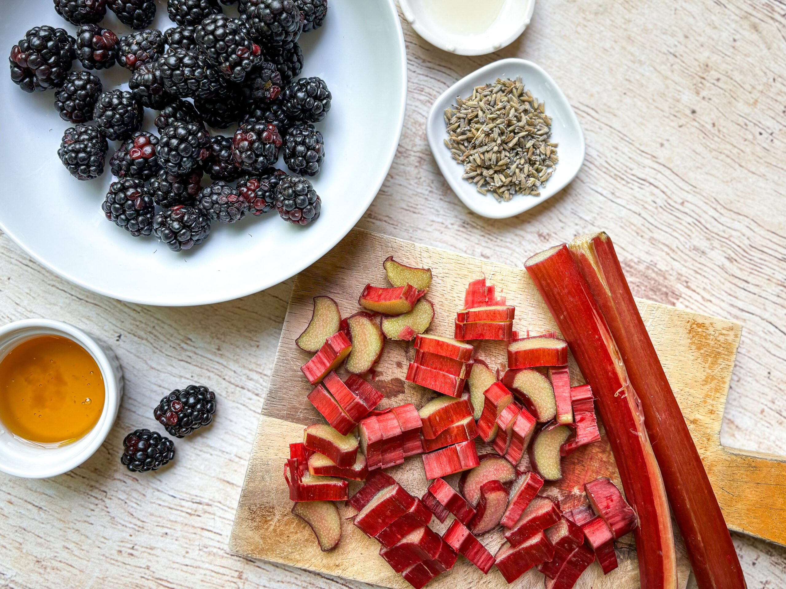 birds eye view prep photo of rhubarb chopped up on cutting board with other ingredients for vegetable fruit roll-up