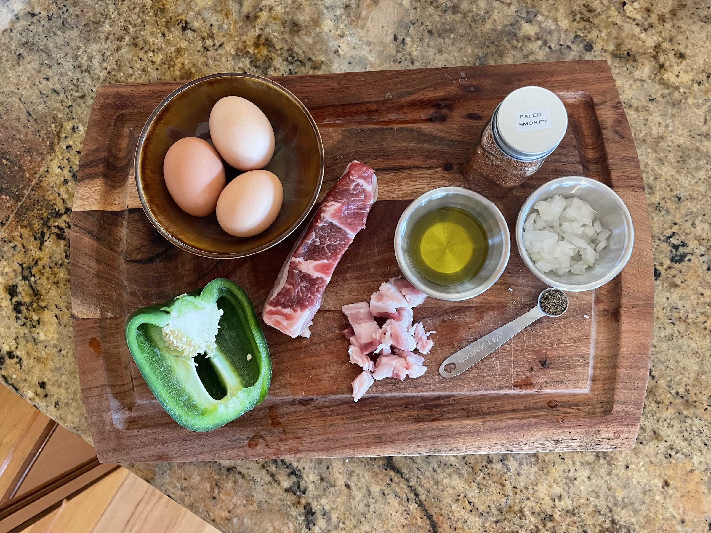 Western omelet ingredients on a wooden cutting board.