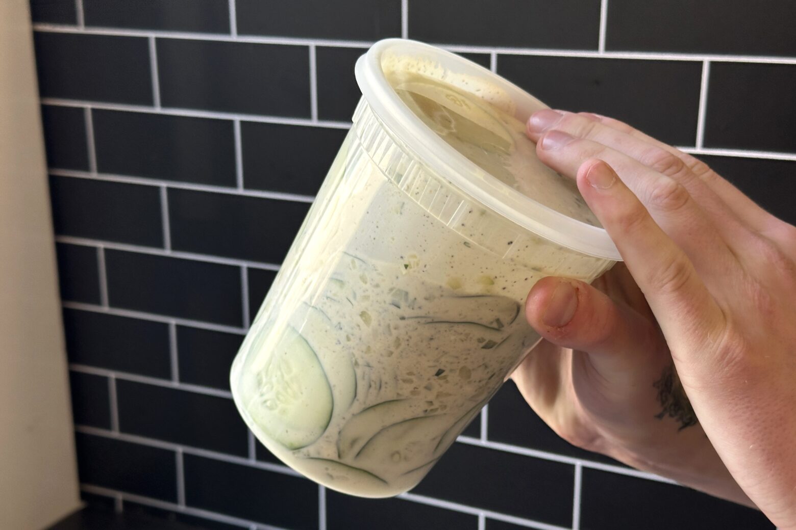 Shaking Cucumber Salad up in a container