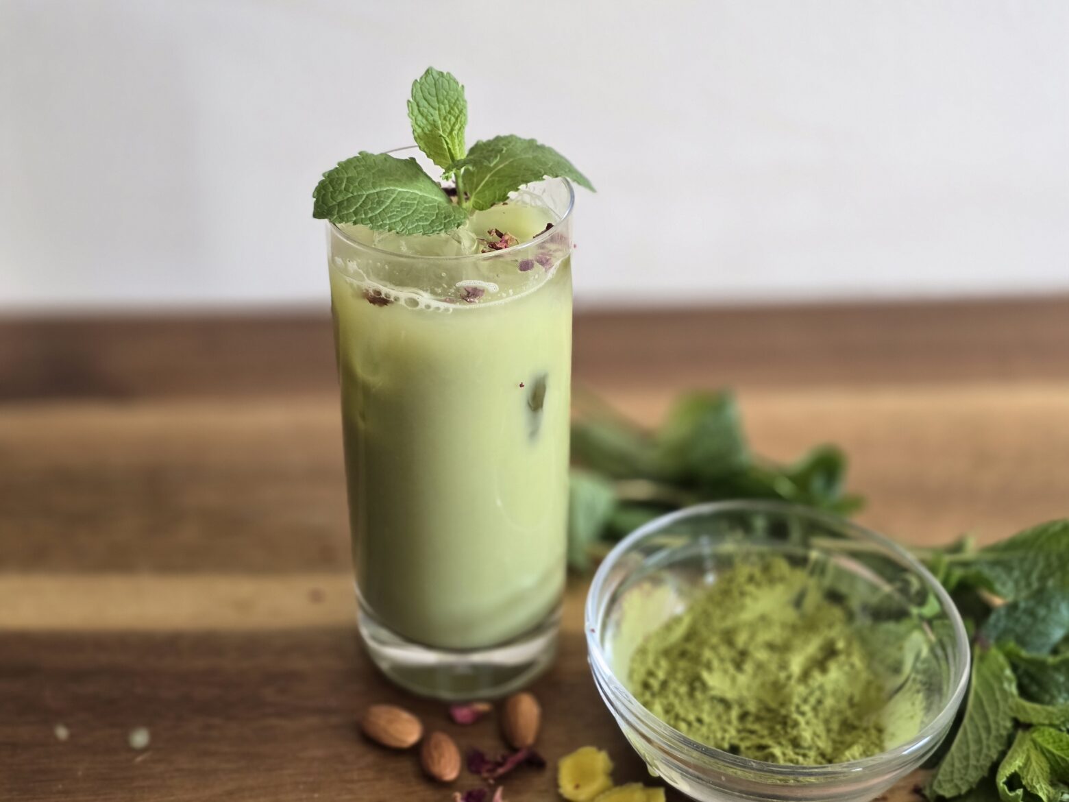 Iced mint matcha in a glass over ice.