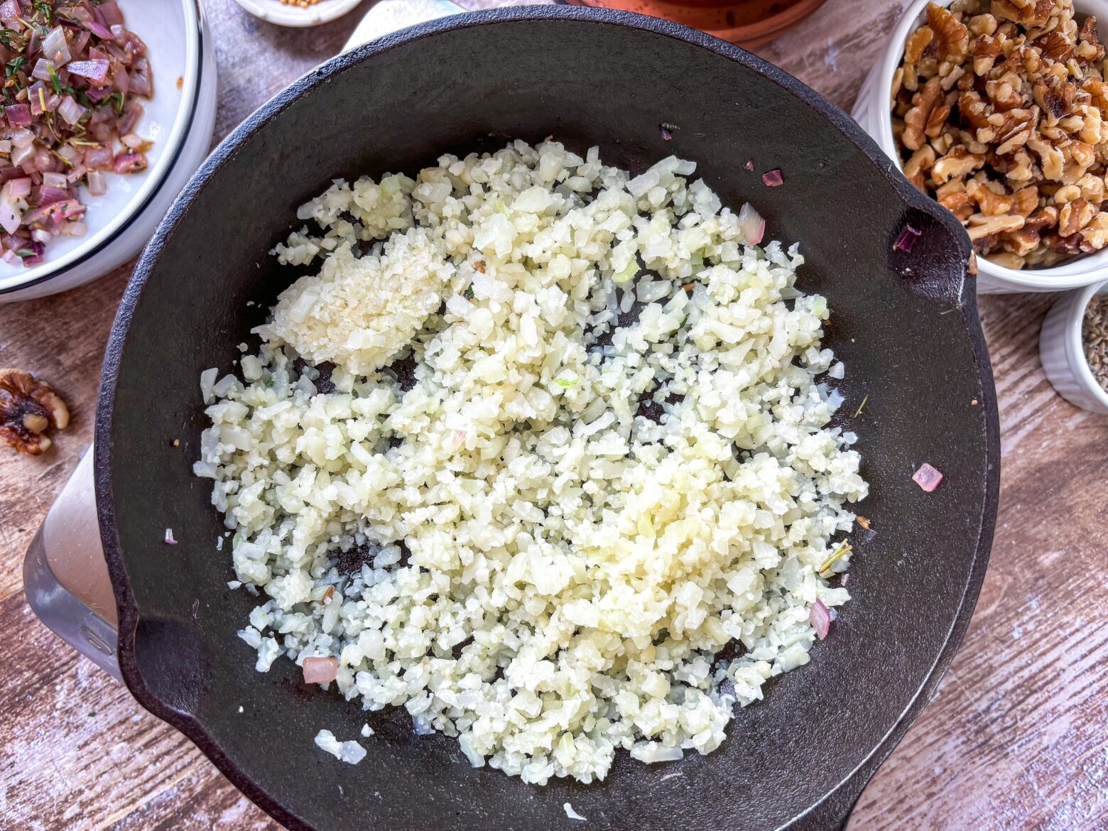 Lavender salad prep for cauliflower rice in cast iron.