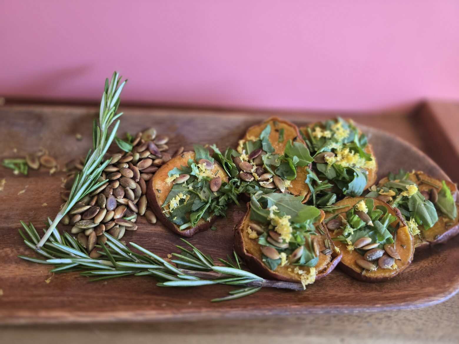 Sweet potato cakes finished on a wooden cutting board.
