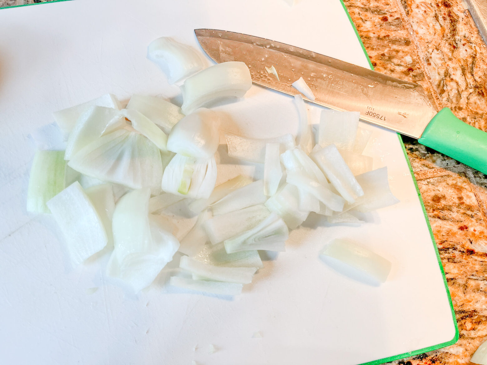 Prepping onions for the orange poached ahlibut.
