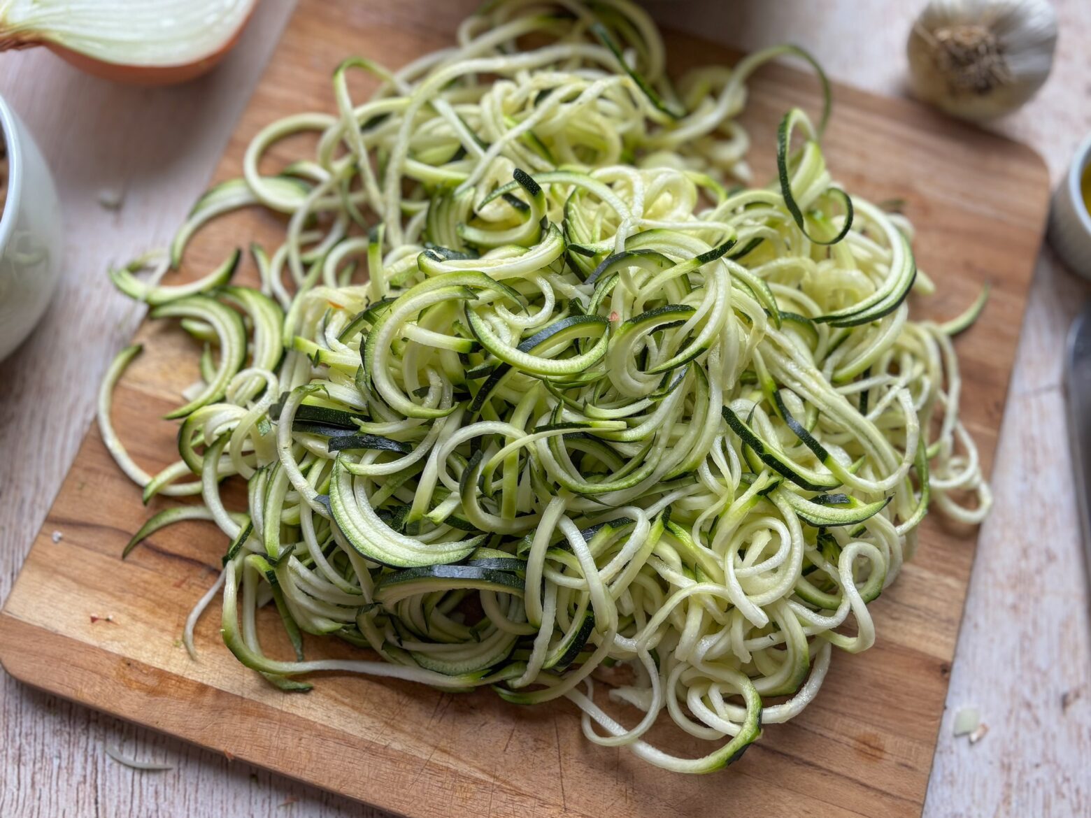 Zoodles on a cutting board being prepped for the tuna casserole.
