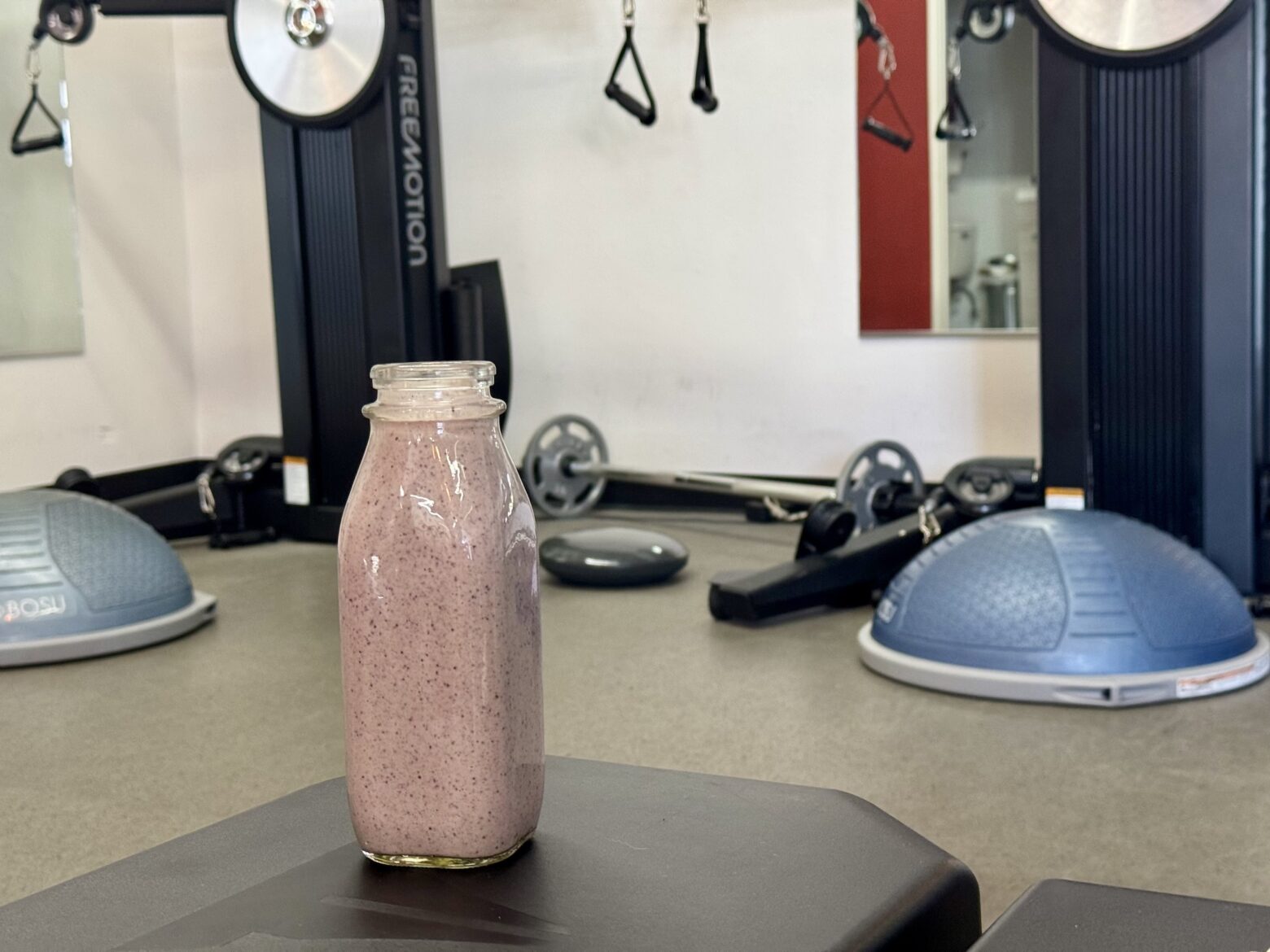 Vegan protein shake at the gym, on the bench.
