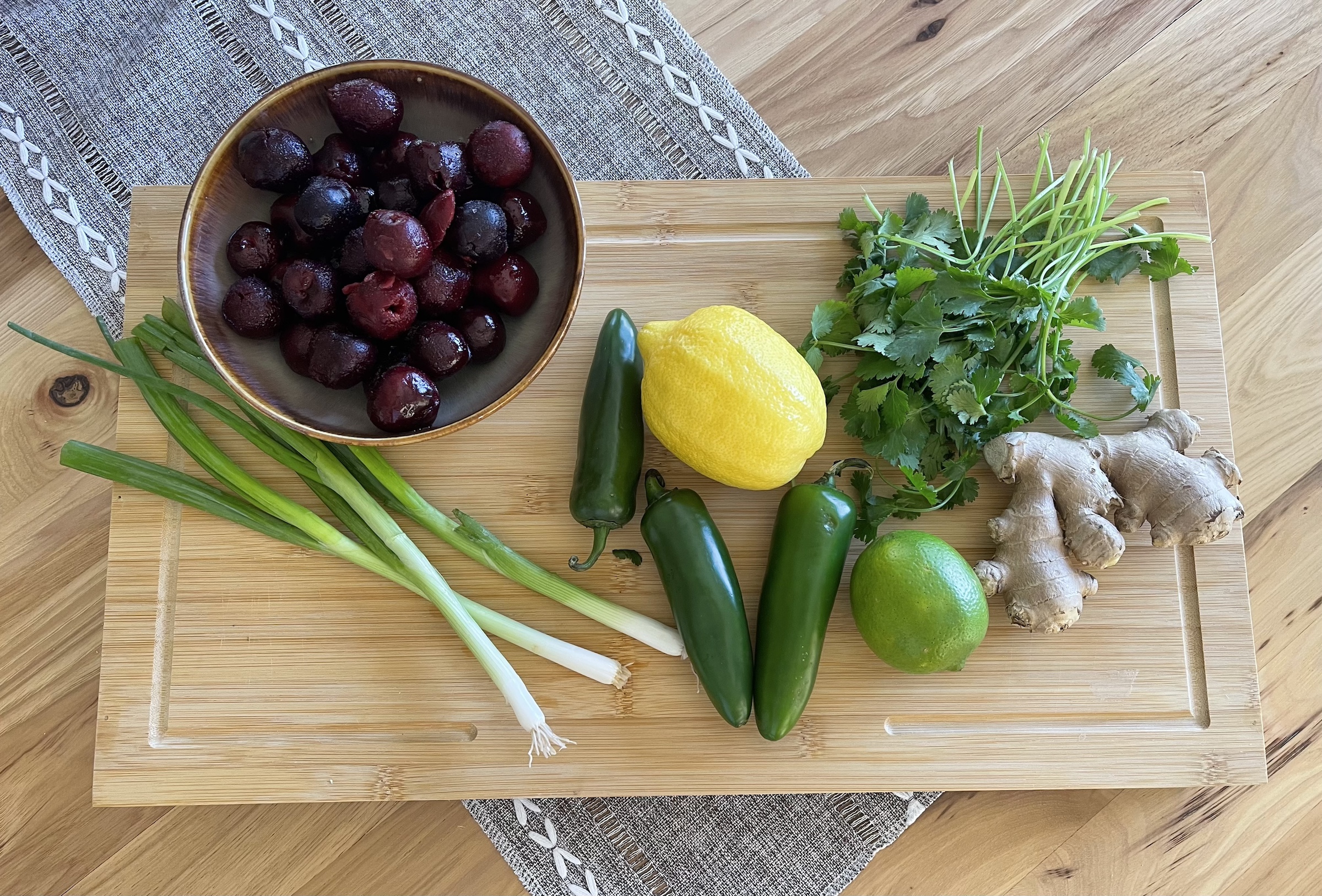Cherry salsa ingredietns on a cutting board. 