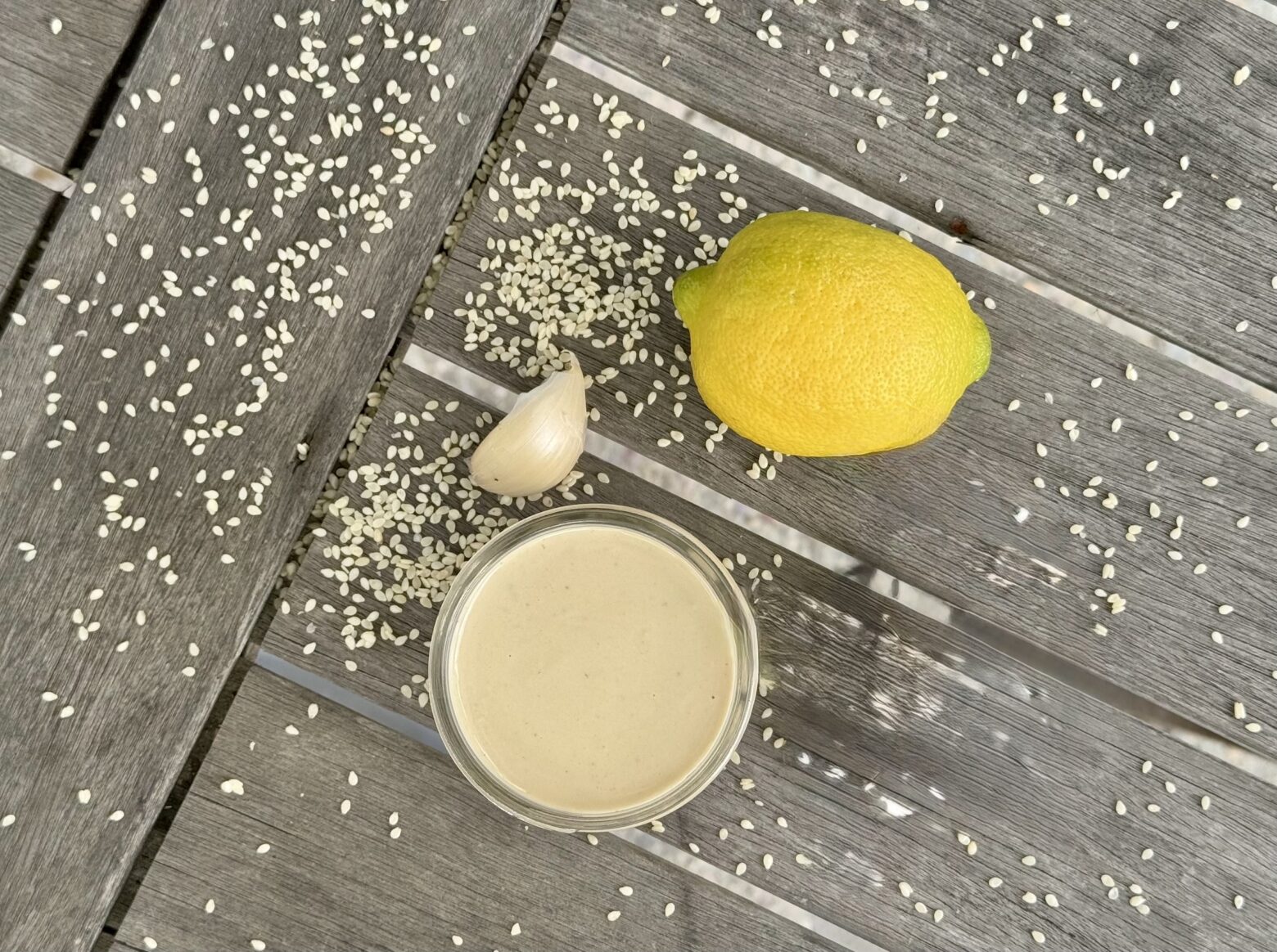 Lemon Tahini Dressing finished, on a table.