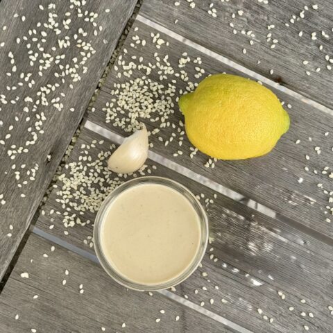 Lemon Tahini Dressing finished, on a table.
