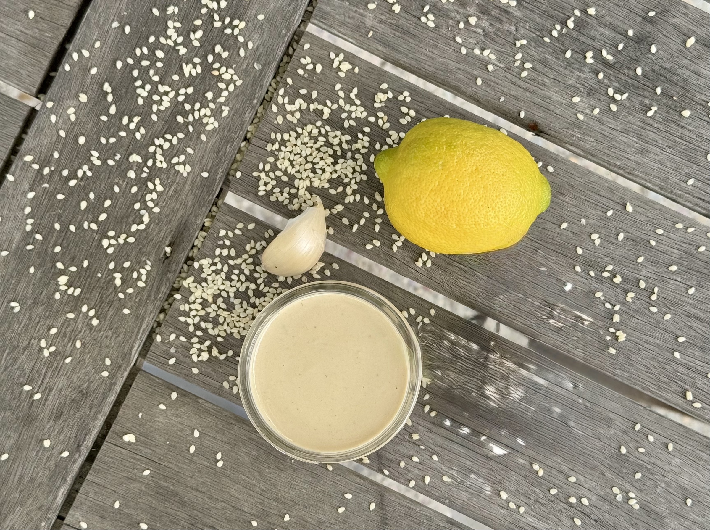 Lemon Tahini Dressing finished, on a table.