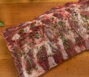 Certified Piedmontese grass fed finished meaty beef back ribs product photo.