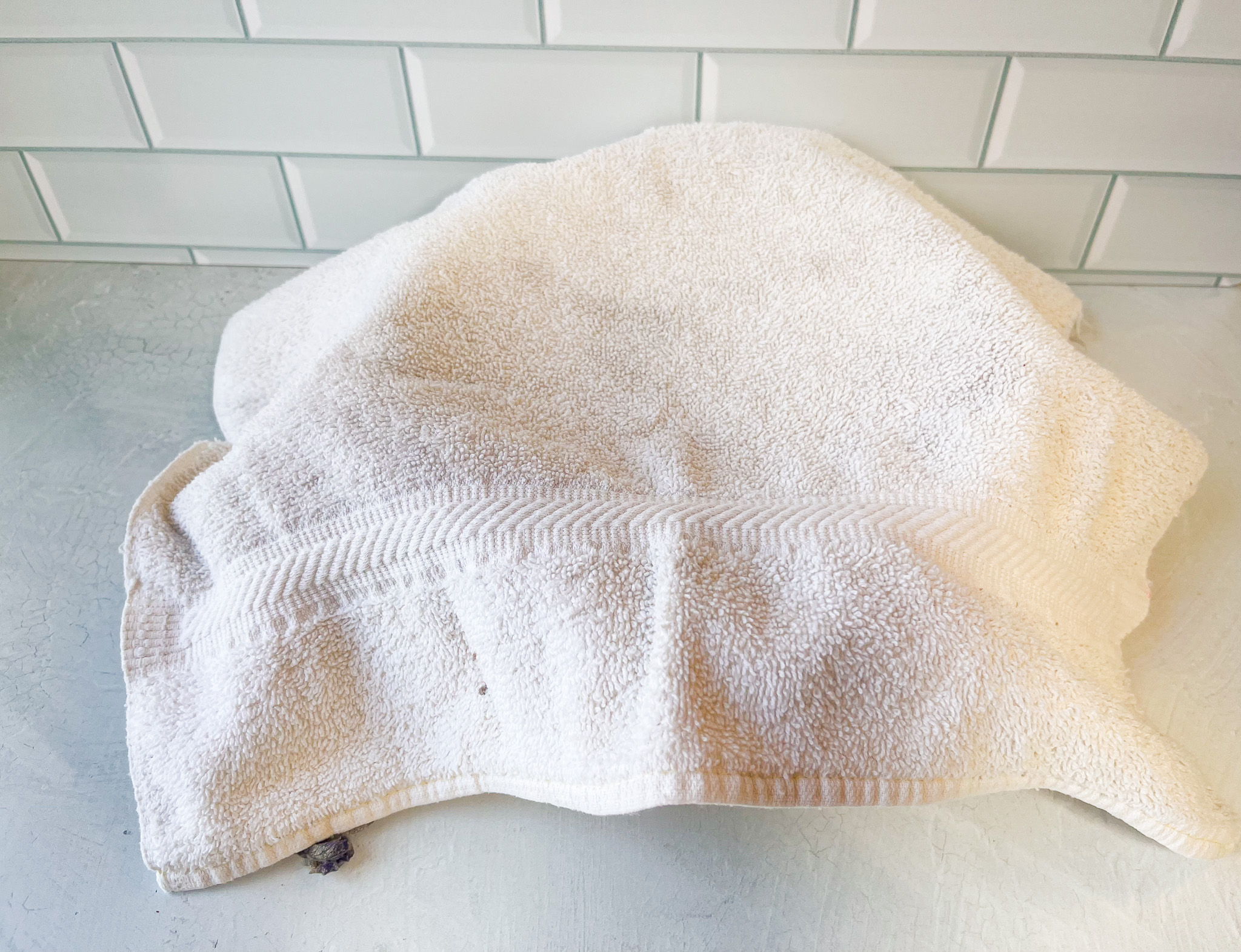 Lavender flaxseed facemask preparation with a towel. 