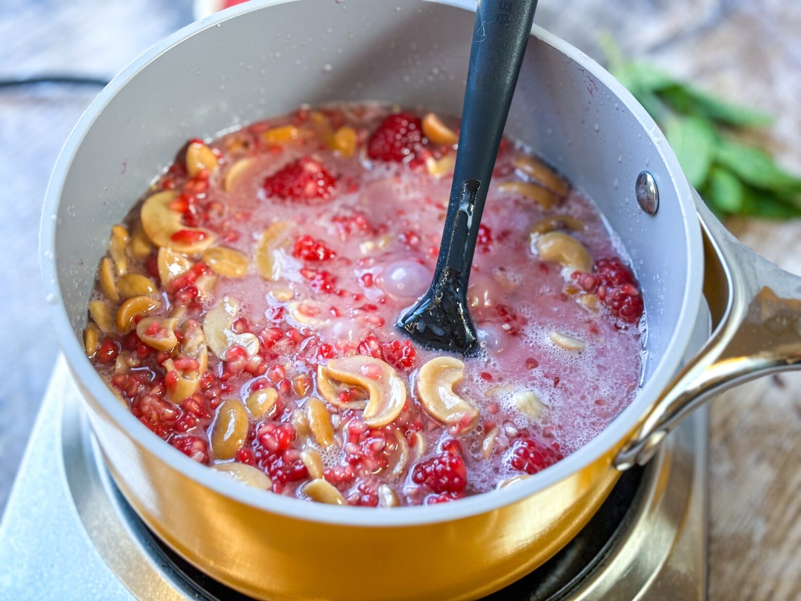 Raspberry mini tart being prepped over the stove.