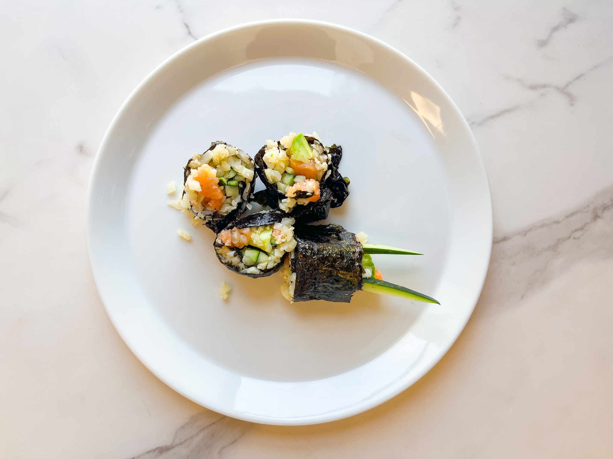 Plaeo sushi roll zoomed out on a plate. 