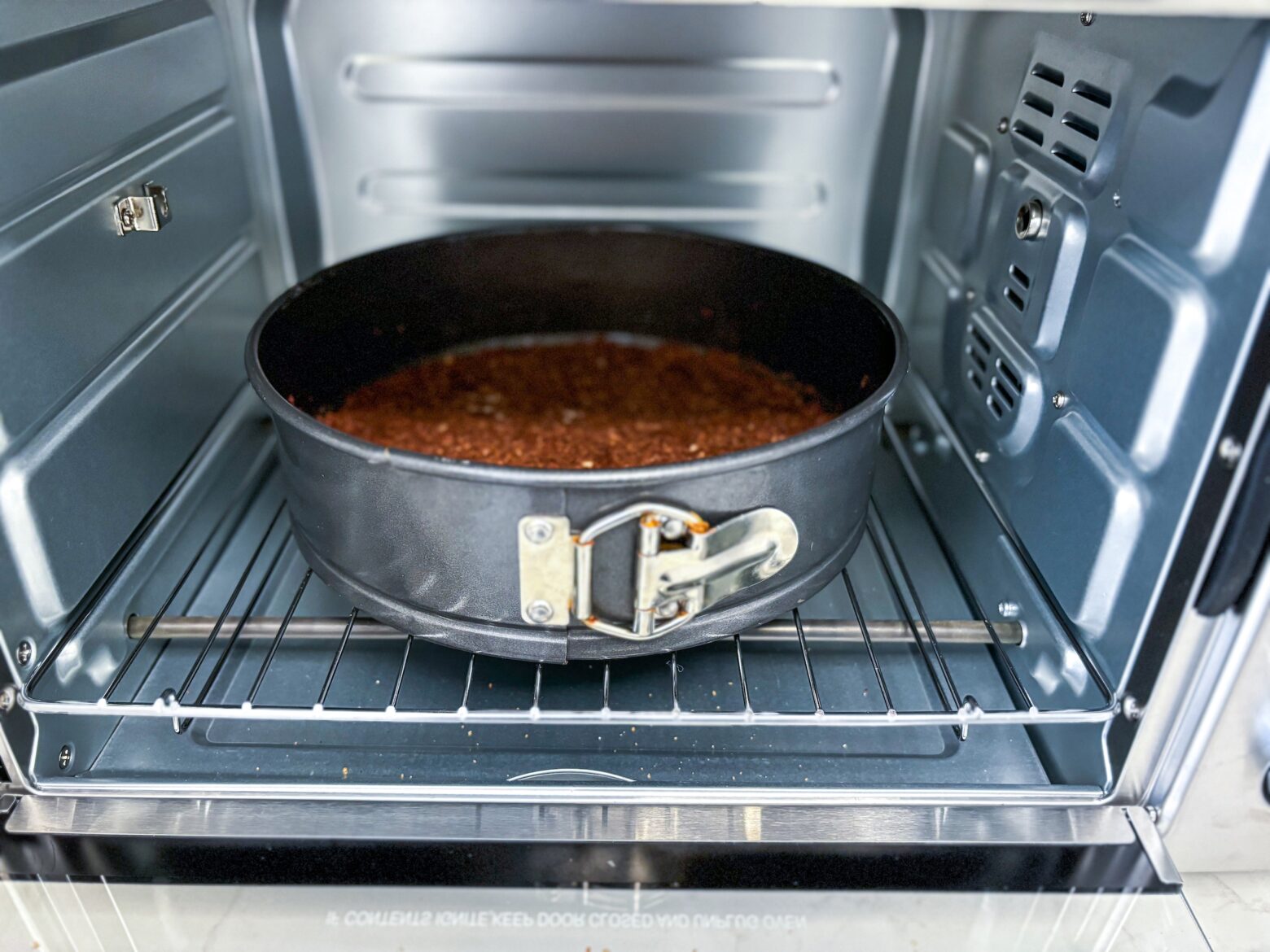 Raspberry mini tart crust in oven.