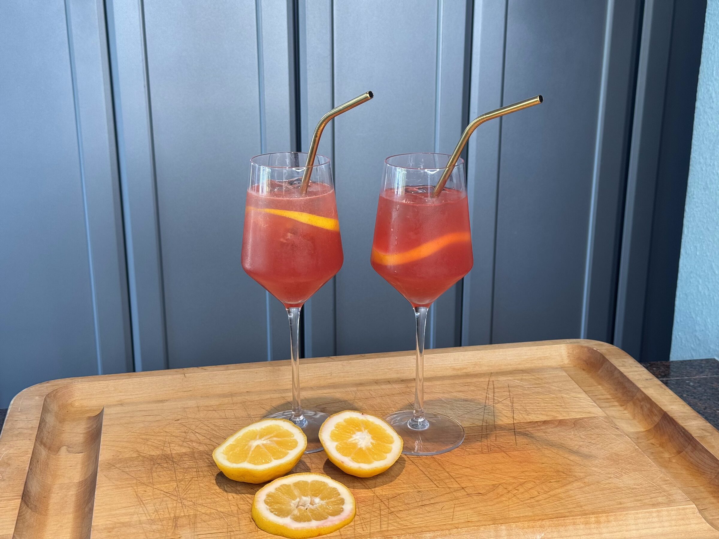Aperol spritz finished, infront of a blue cabinet. 