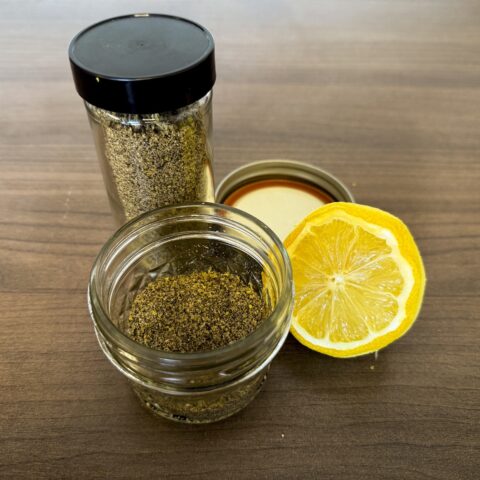 Final photo of lemon pepper seasoning in jars with halved lemon