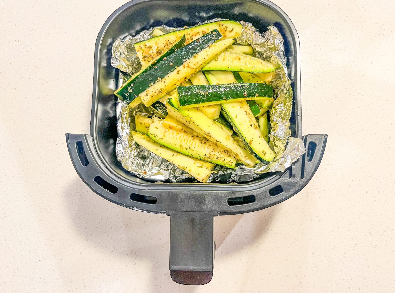 Air fryer zucchini in the air fryer basket.