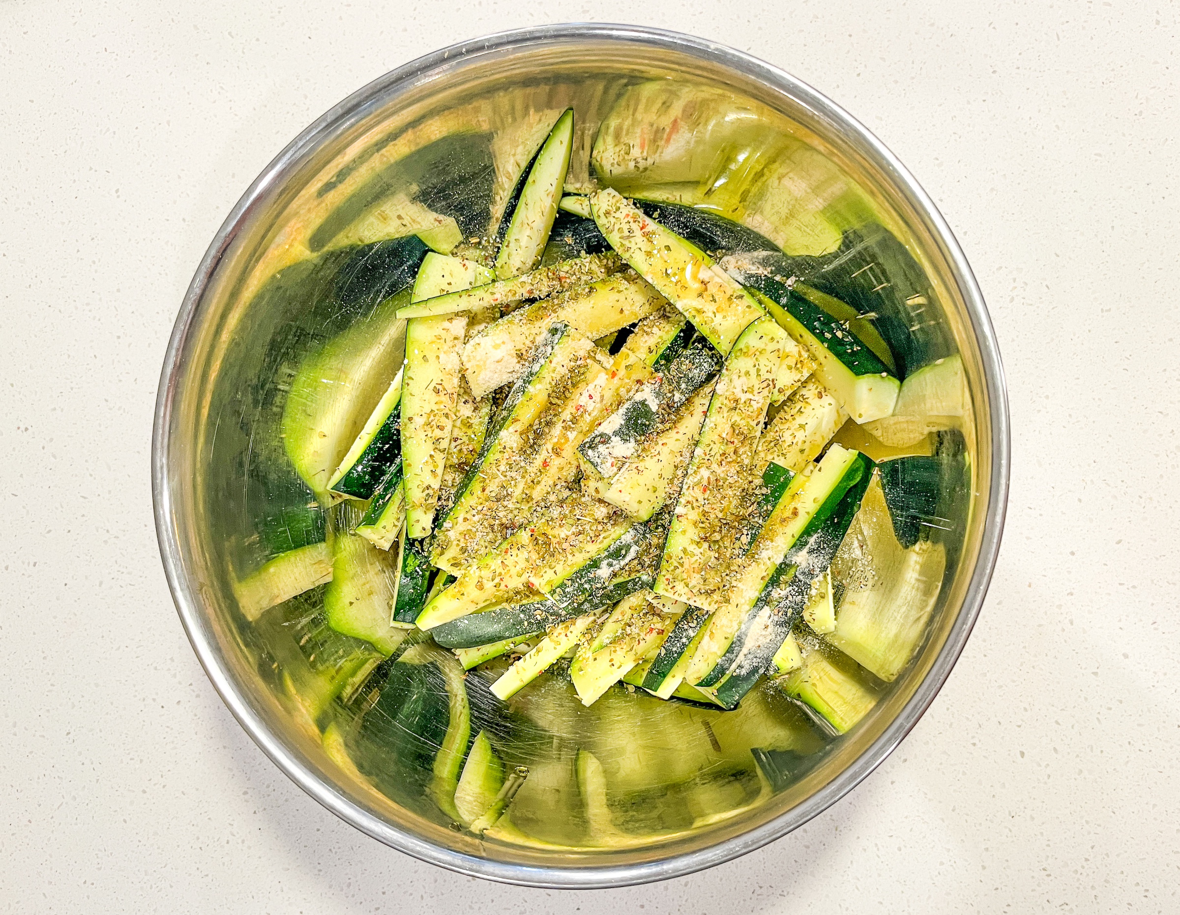 Air fryer zucchini preparation with spices. 
