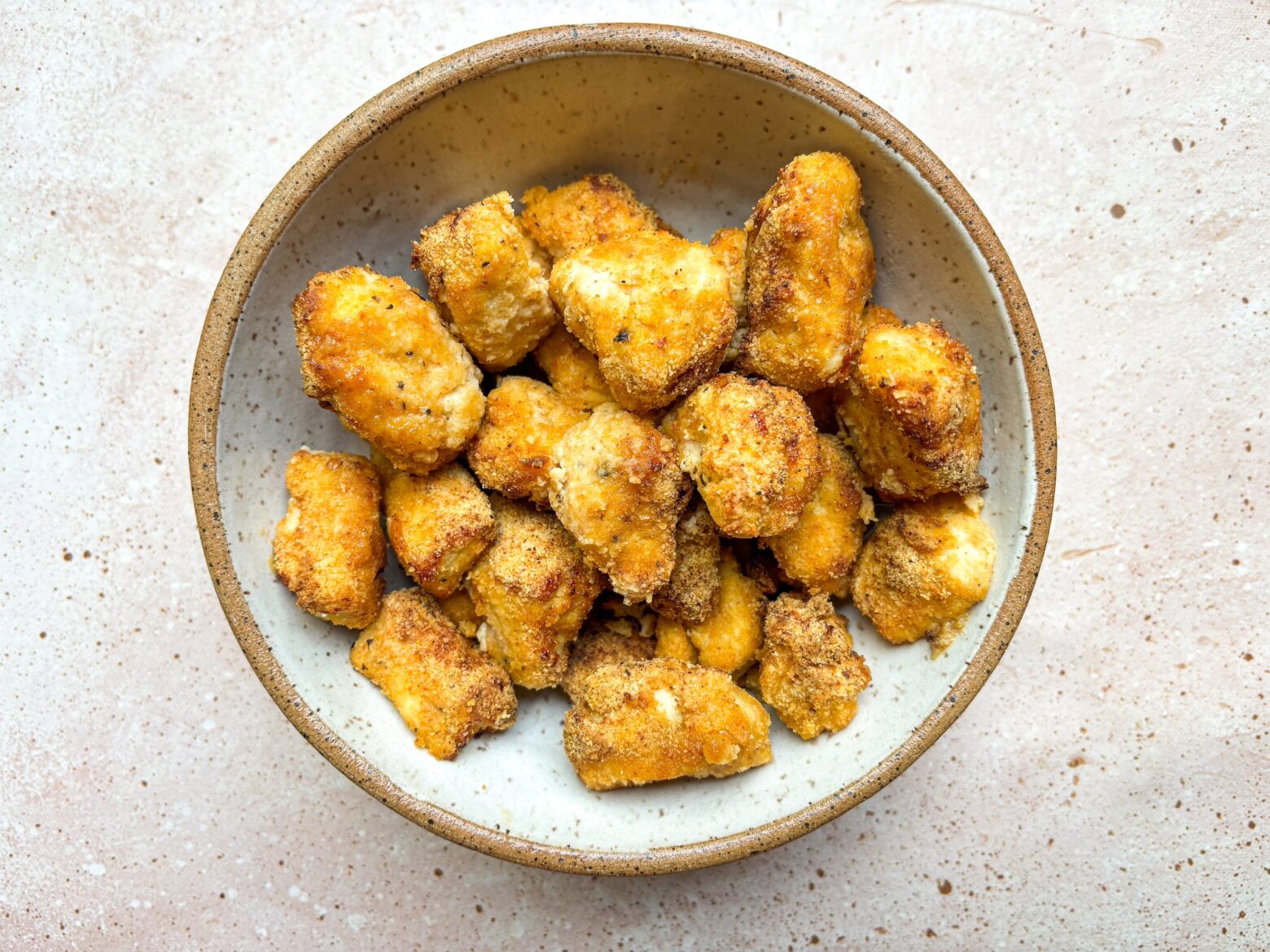 Baked chicken bites finished in a bowl.